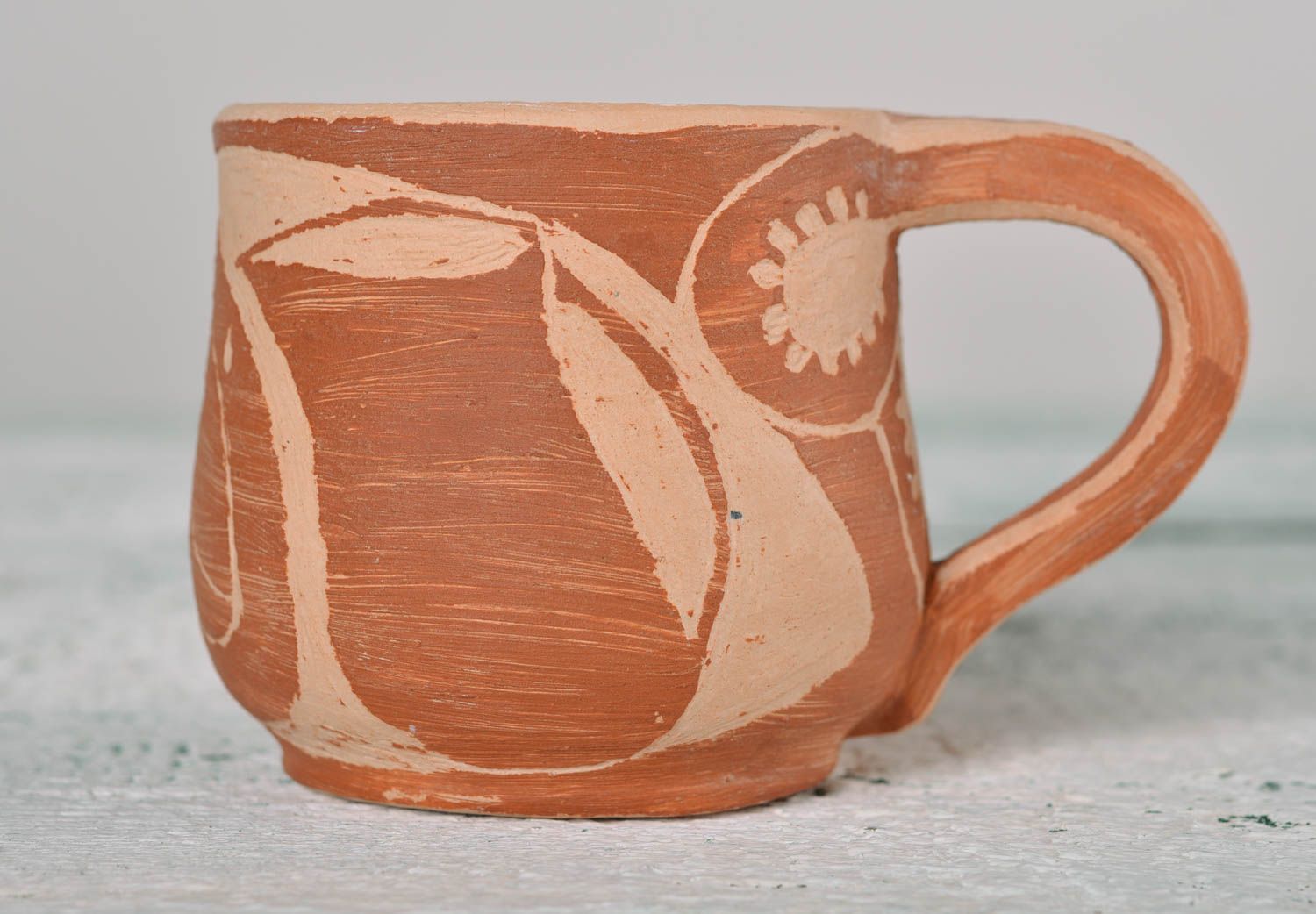 Rustic style clay not glazed cup in light brown and beige colors and handle photo 1