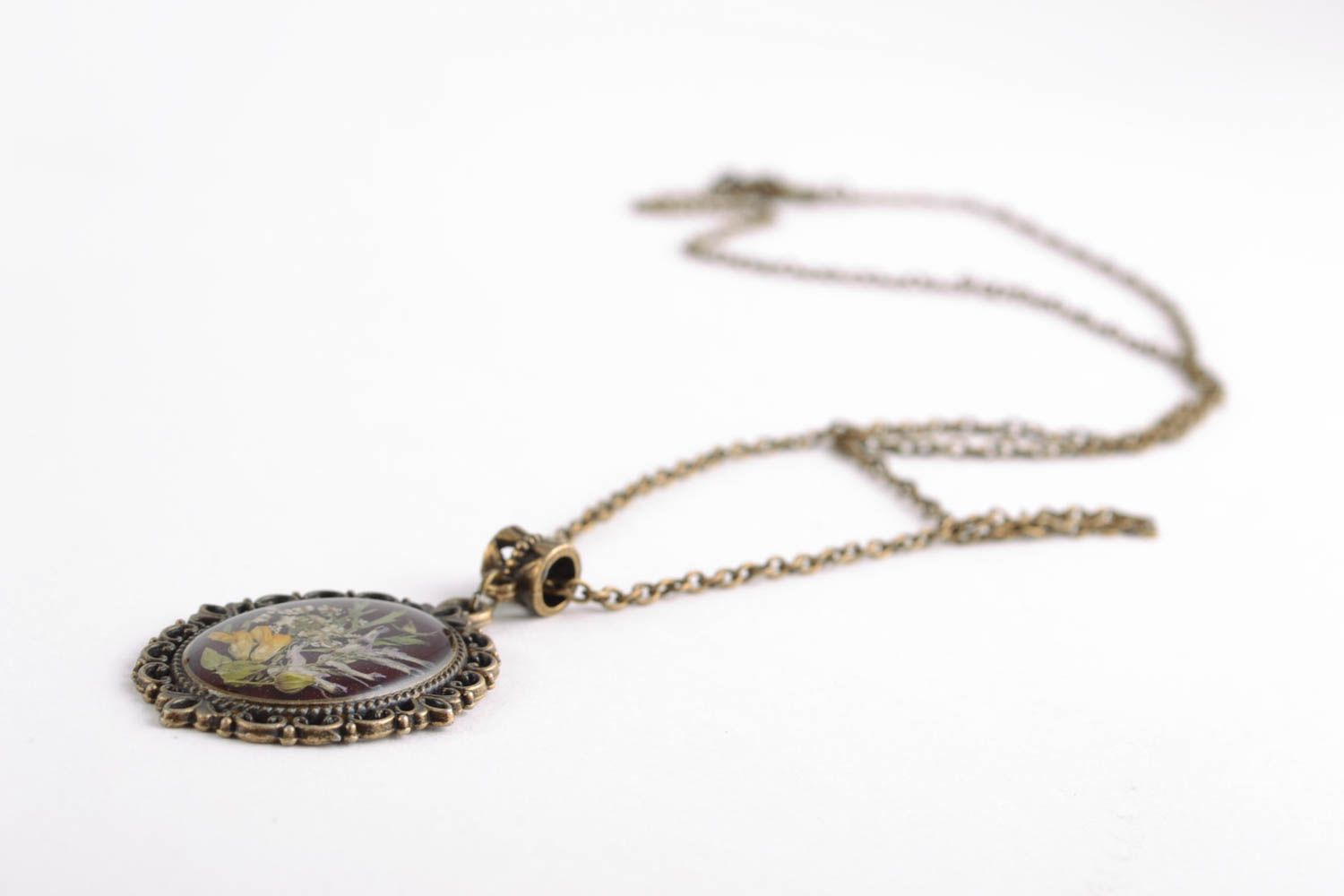 Oval pendant with dried flowers in epoxy resin on long chain photo 3
