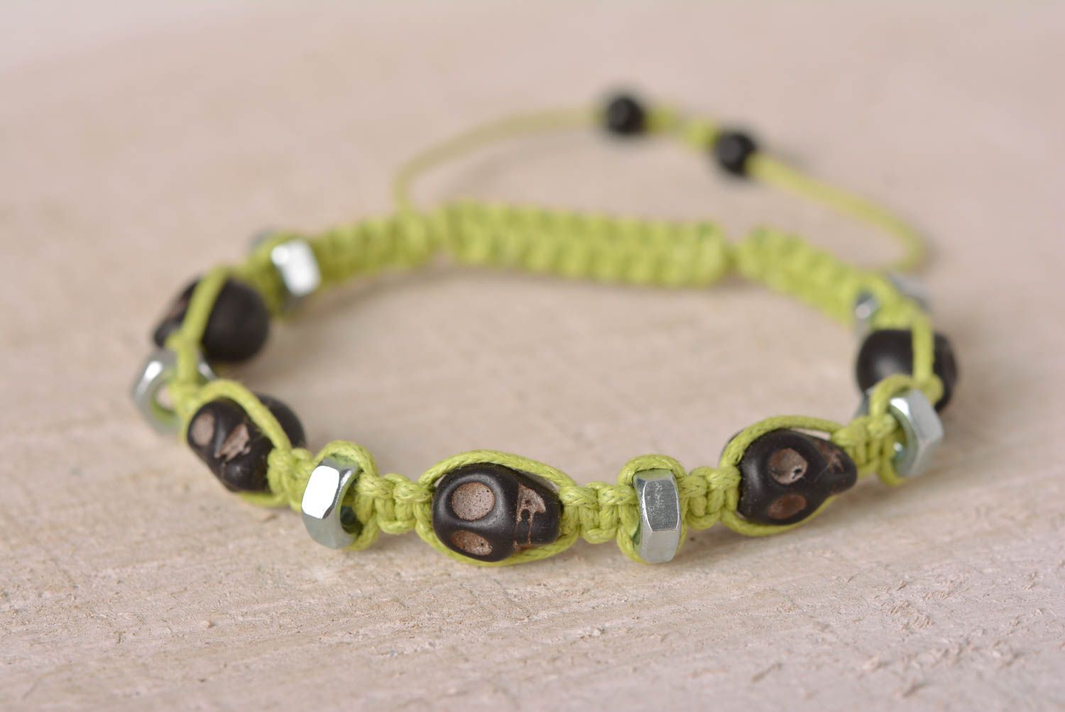 Handmade black skull color beads on light green cord bracelet with female screws photo 1
