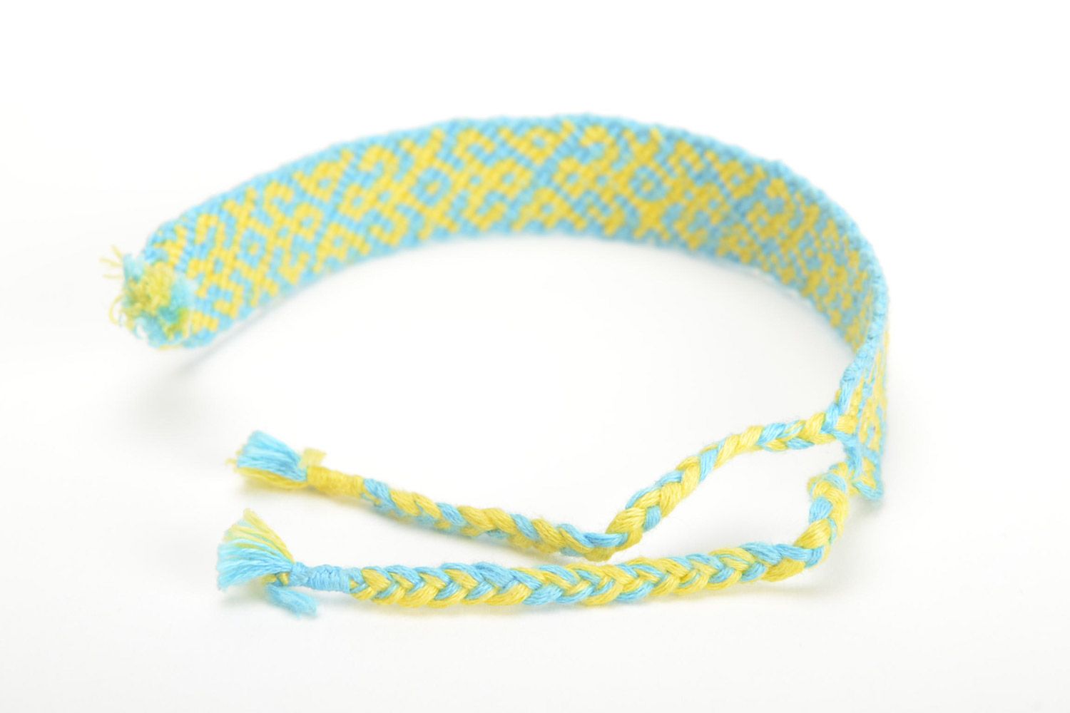 Handmade friendship wrist bracelet woven of blue and yellow threads with ties photo 3