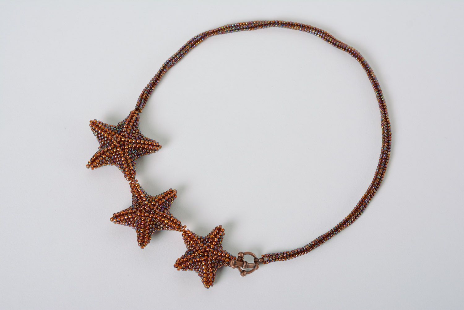 Handmade large necklace woven of beads of bronze color with three stars photo 2