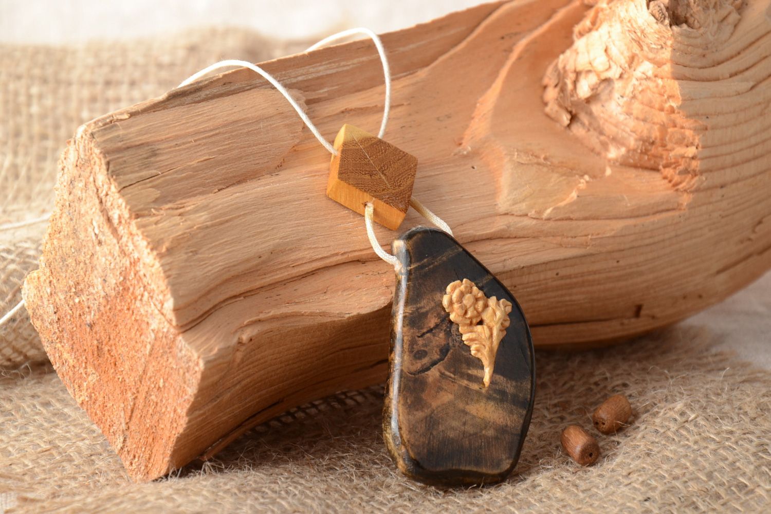 Beautiful handmade neck pendant carved of wood and varnished with synthetic cord photo 1