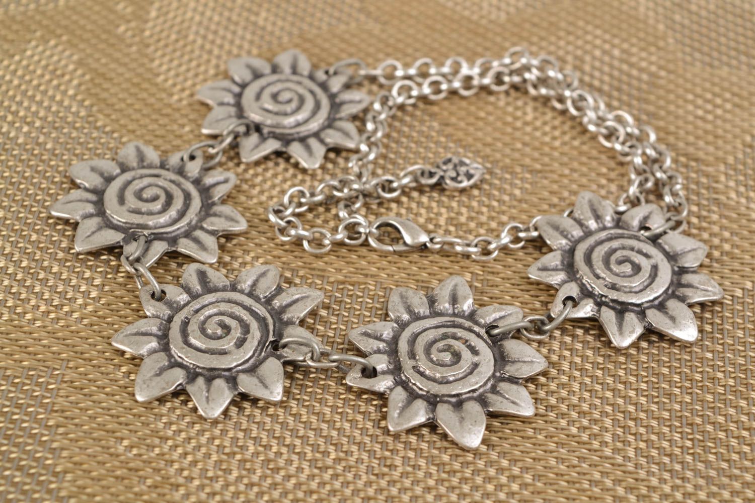 Metal necklace made using permanent mold casting technique with sunflowers photo 1
