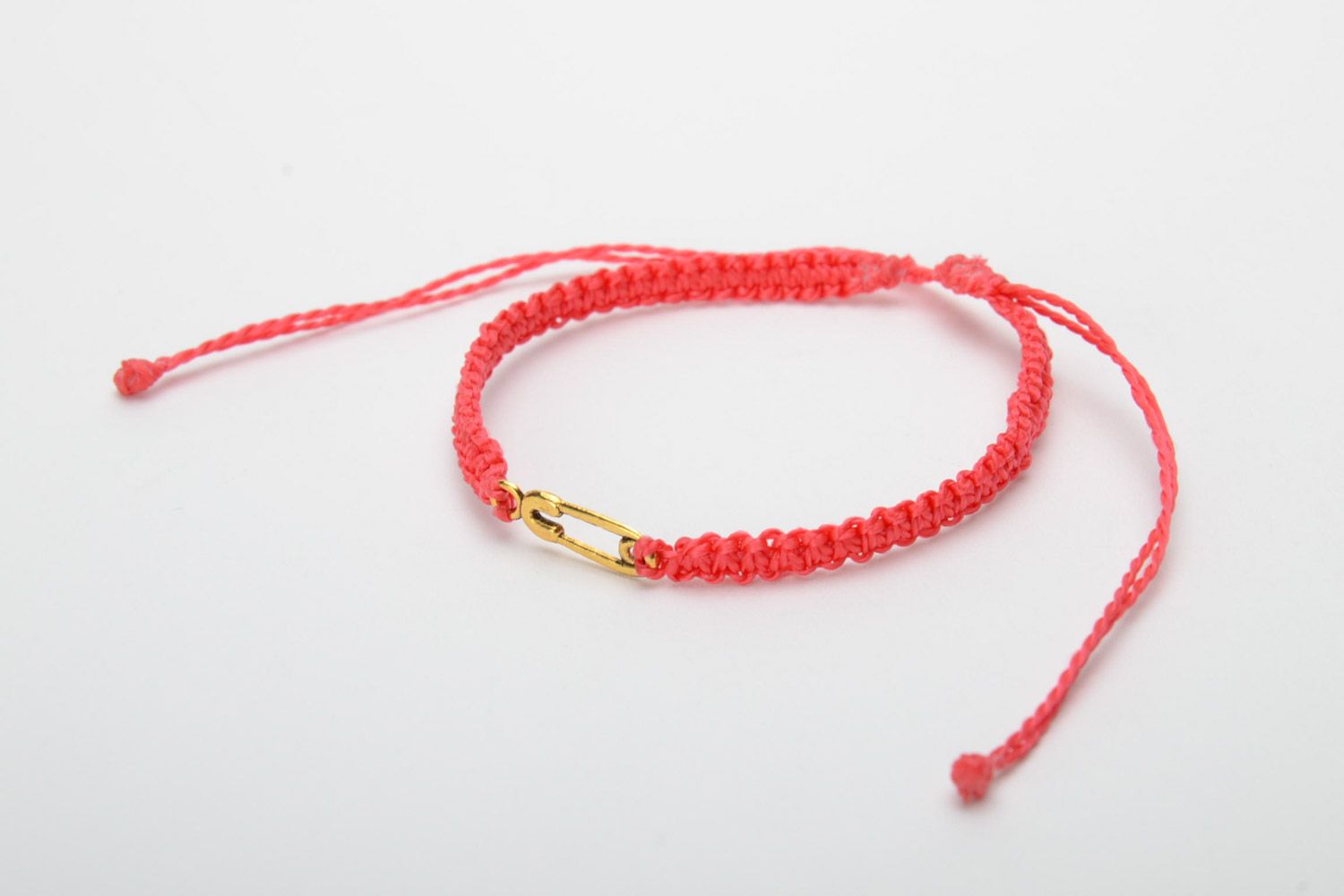 Handmade women's woven thread bracelet of red color with metal pin charm photo 3