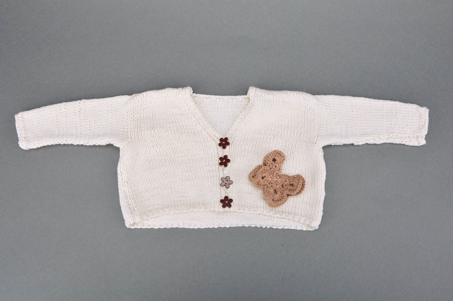 Handmade white jacket crocheted of acrylic threads for baby girl with butterfly photo 2