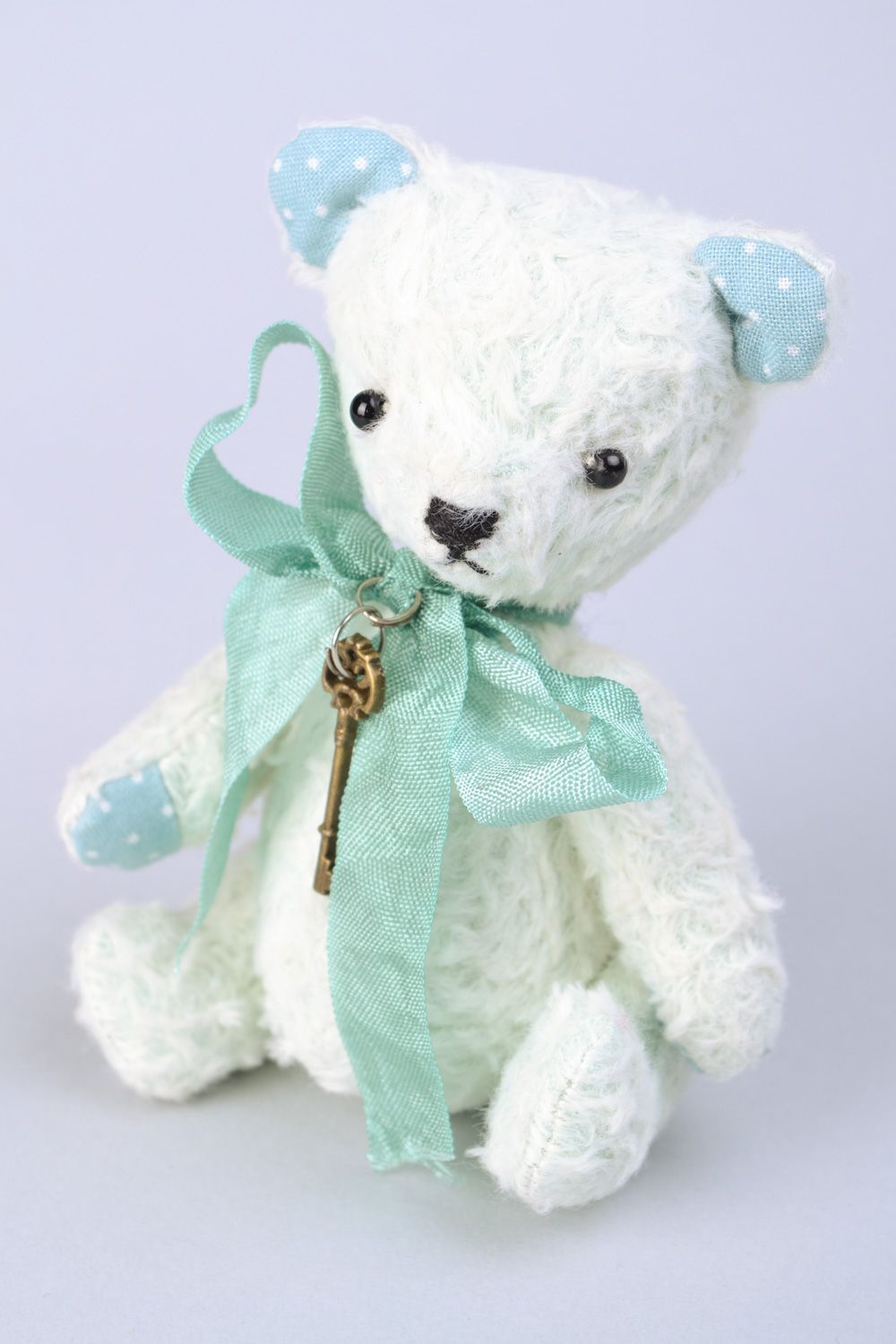 Handmade designer soft toy bear in light color palette with bow and key charm photo 1