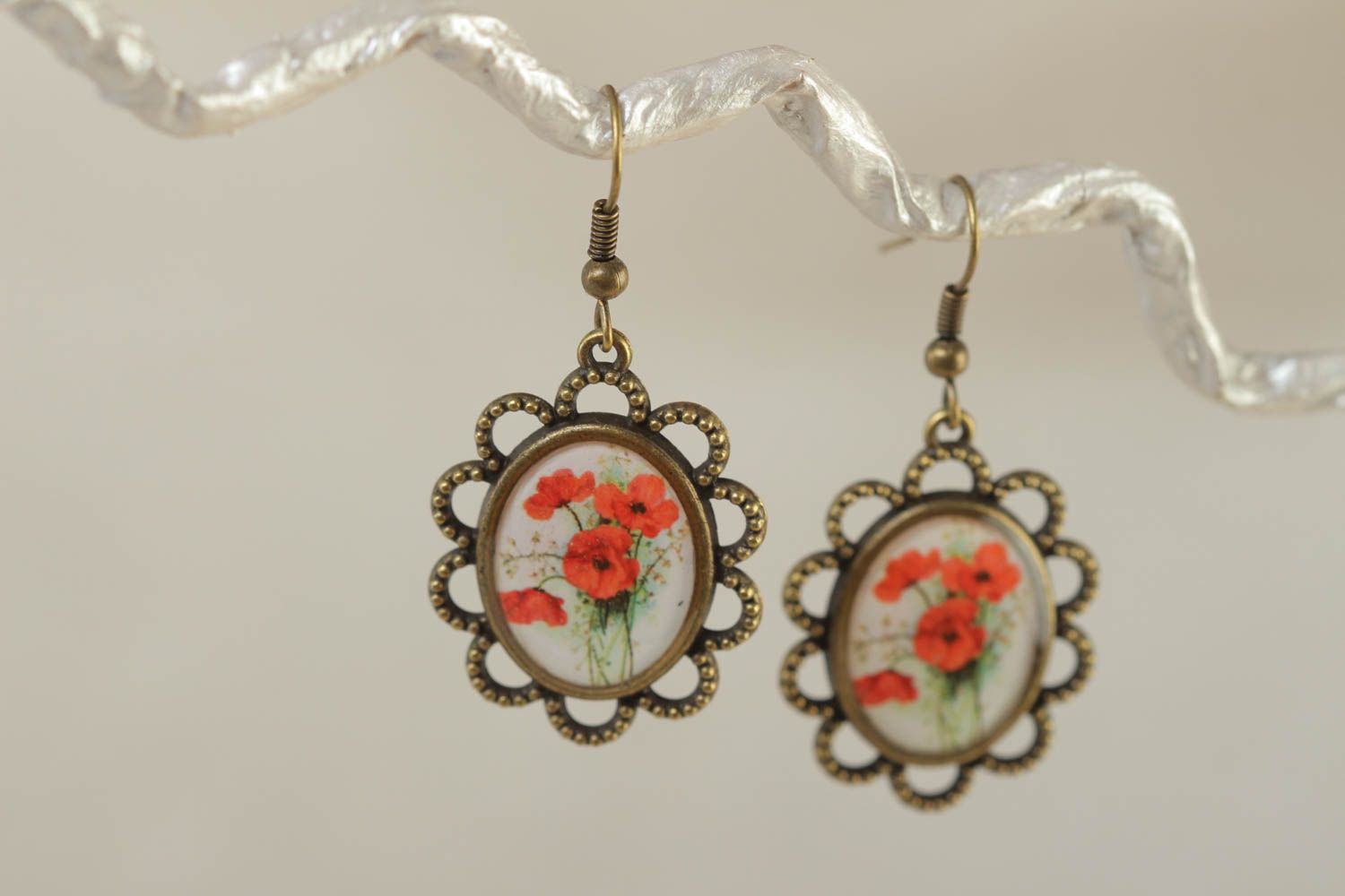 Handmade oval dangling earrings with lacy metal basis and poppy flowers image photo 1