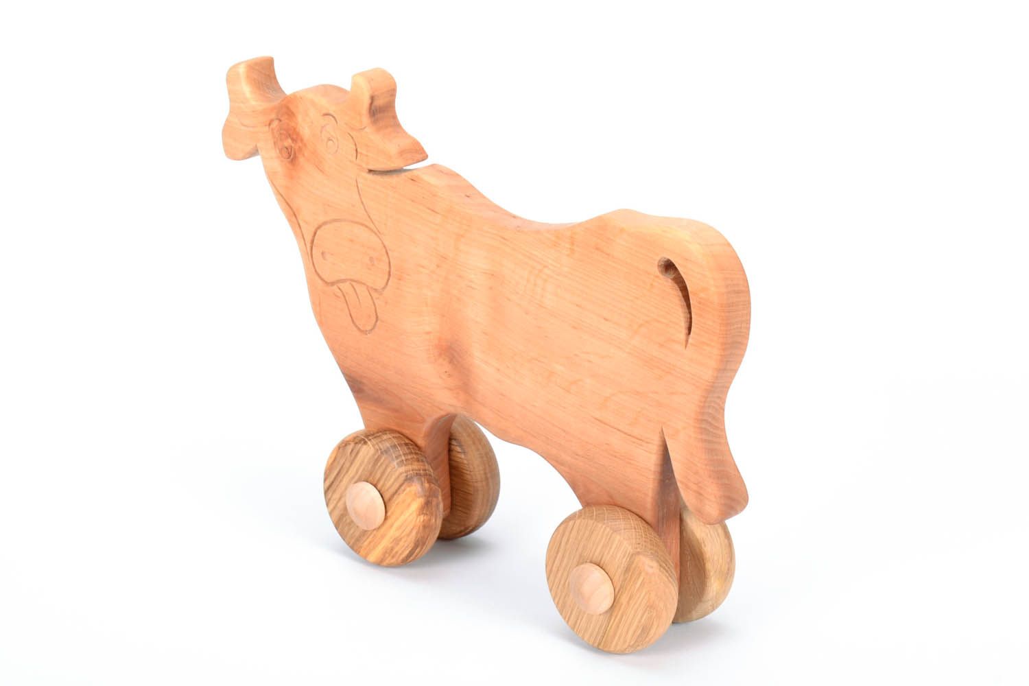 Vaca de madeira engraçada sobre rodas foto 2
