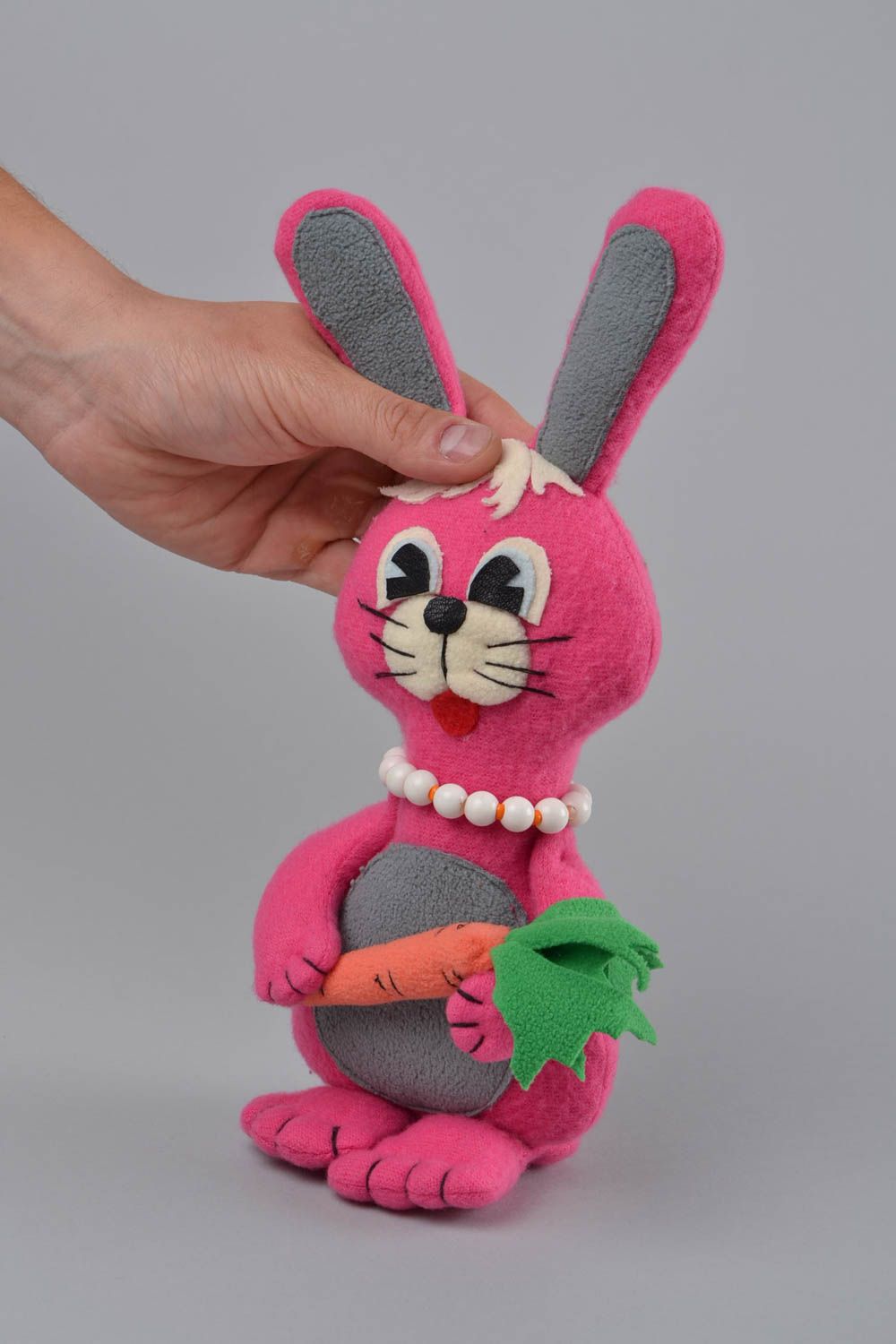 Handmade designer small soft toy sewn of fleece pink rabbit with carrot photo 2