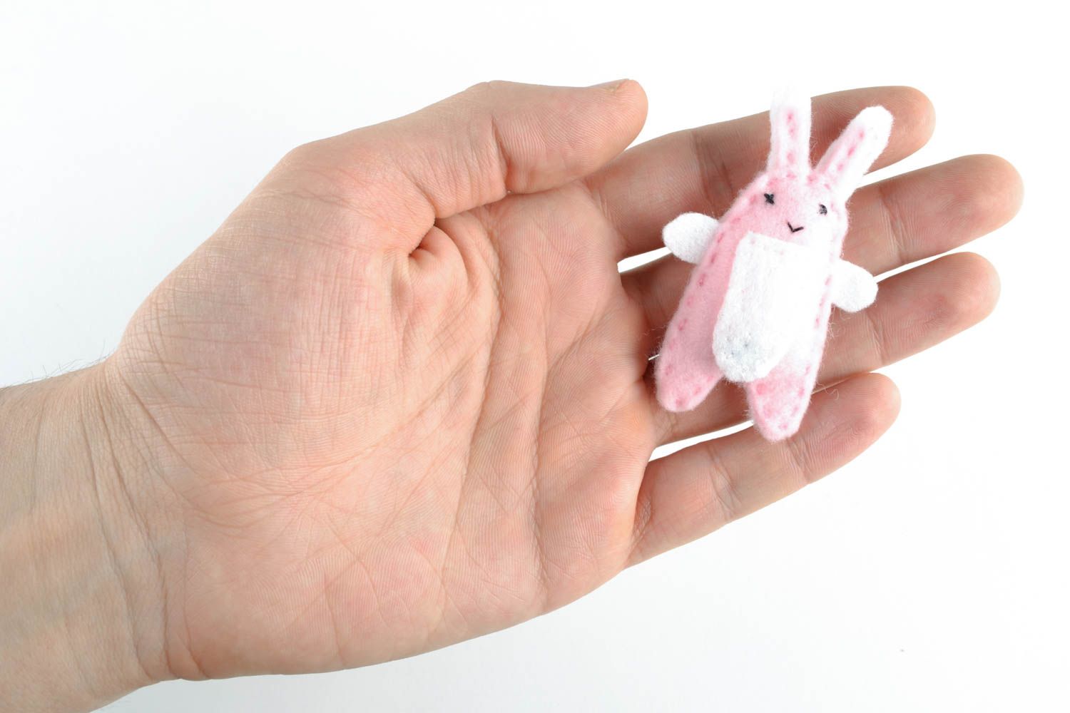 Toy earphone cord holder in the shape of pink hare photo 1