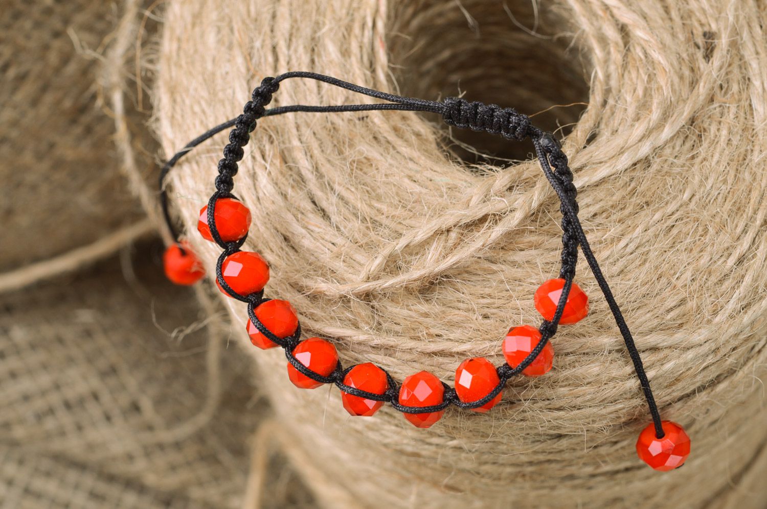 Red and black handmade wrist bracelet woven of threads and beads with ties photo 1