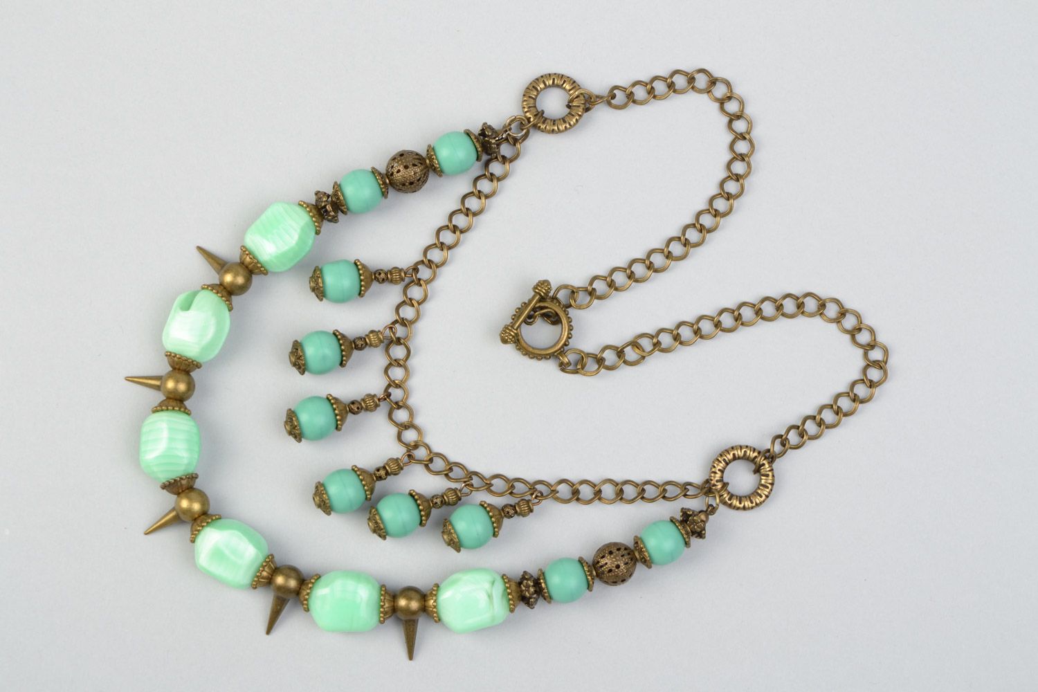 Handmade multi row necklace with glass beads of mint color and metal prickles  photo 3