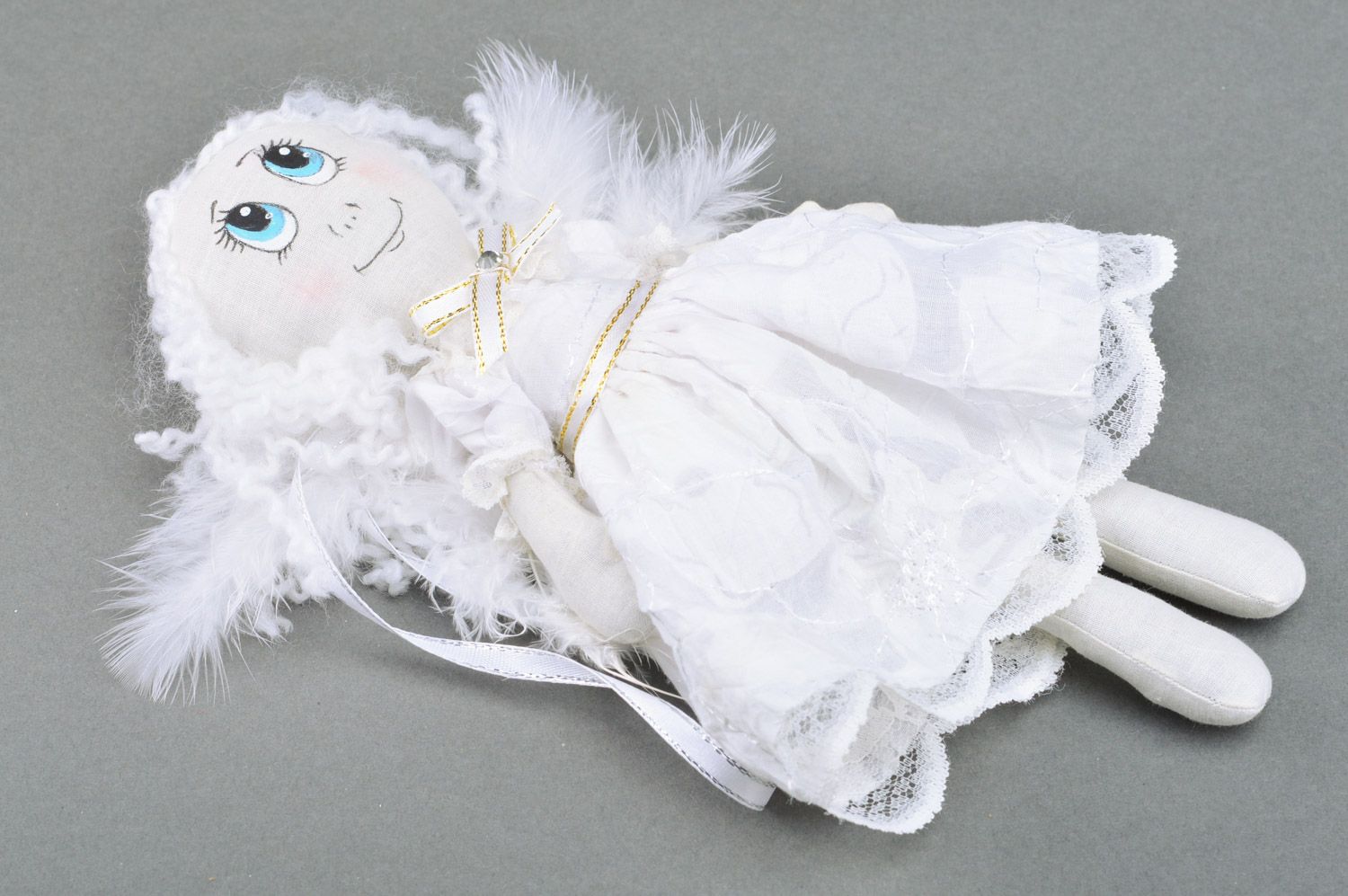 Handmade white fabric soft doll of average size with wings made of feathers photo 2