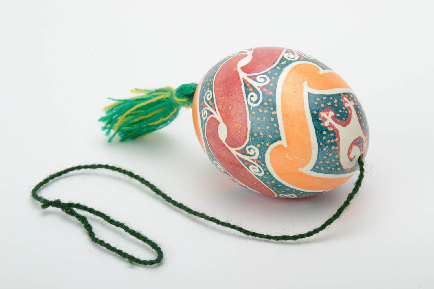 Handmade decorative colorful painted Easter egg pysanka with green tassel photo 2