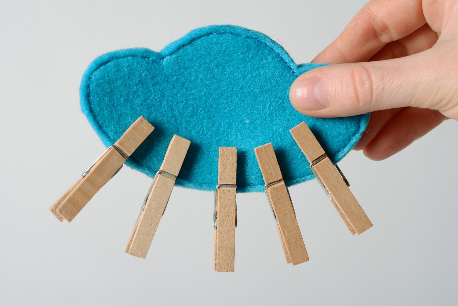 Handmade educational toy of blue color sewn of felt with clothes pins Cloud photo 1