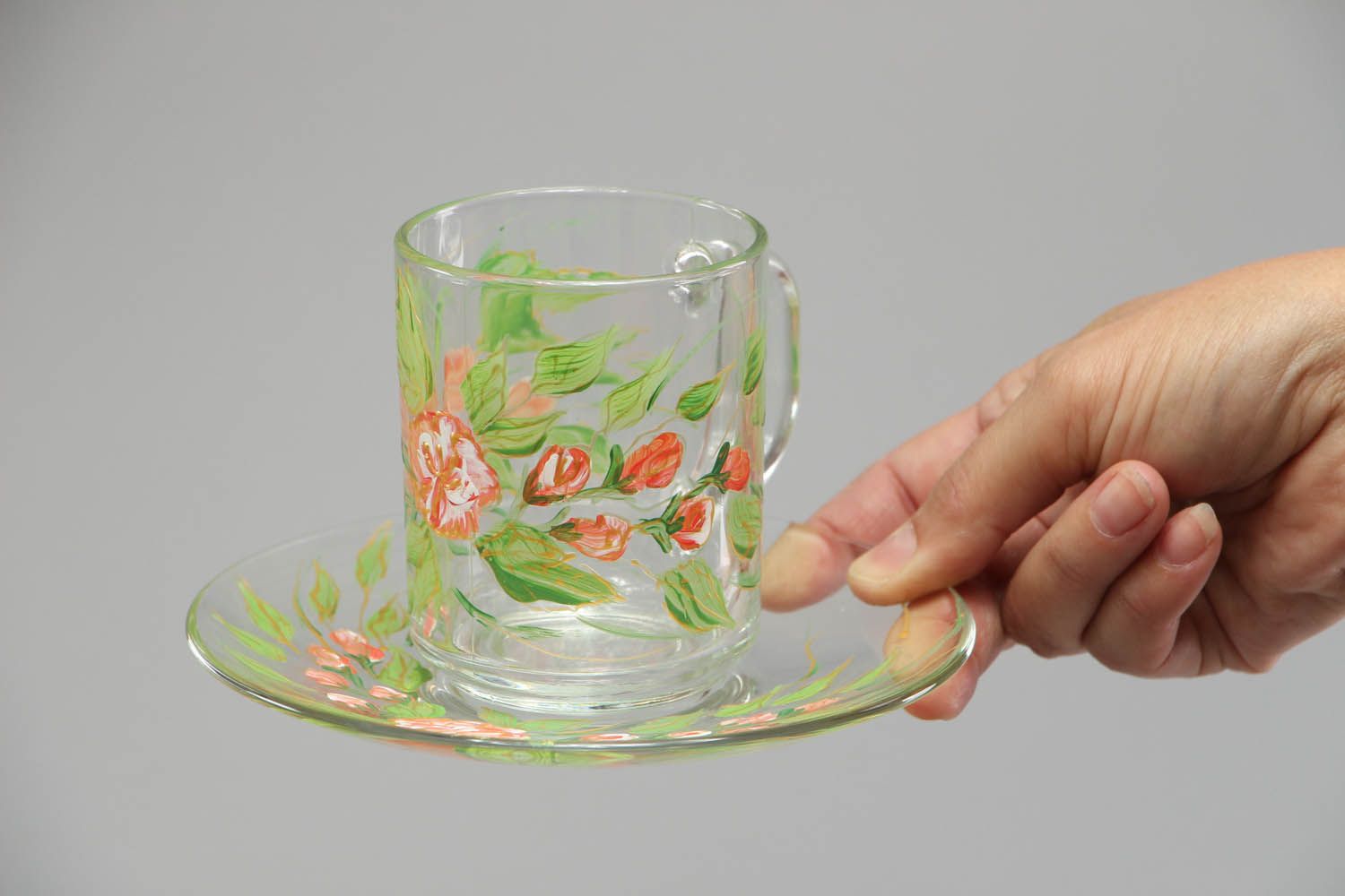 Clear glass tea cup with handle and saucer in green floral pattern photo 3