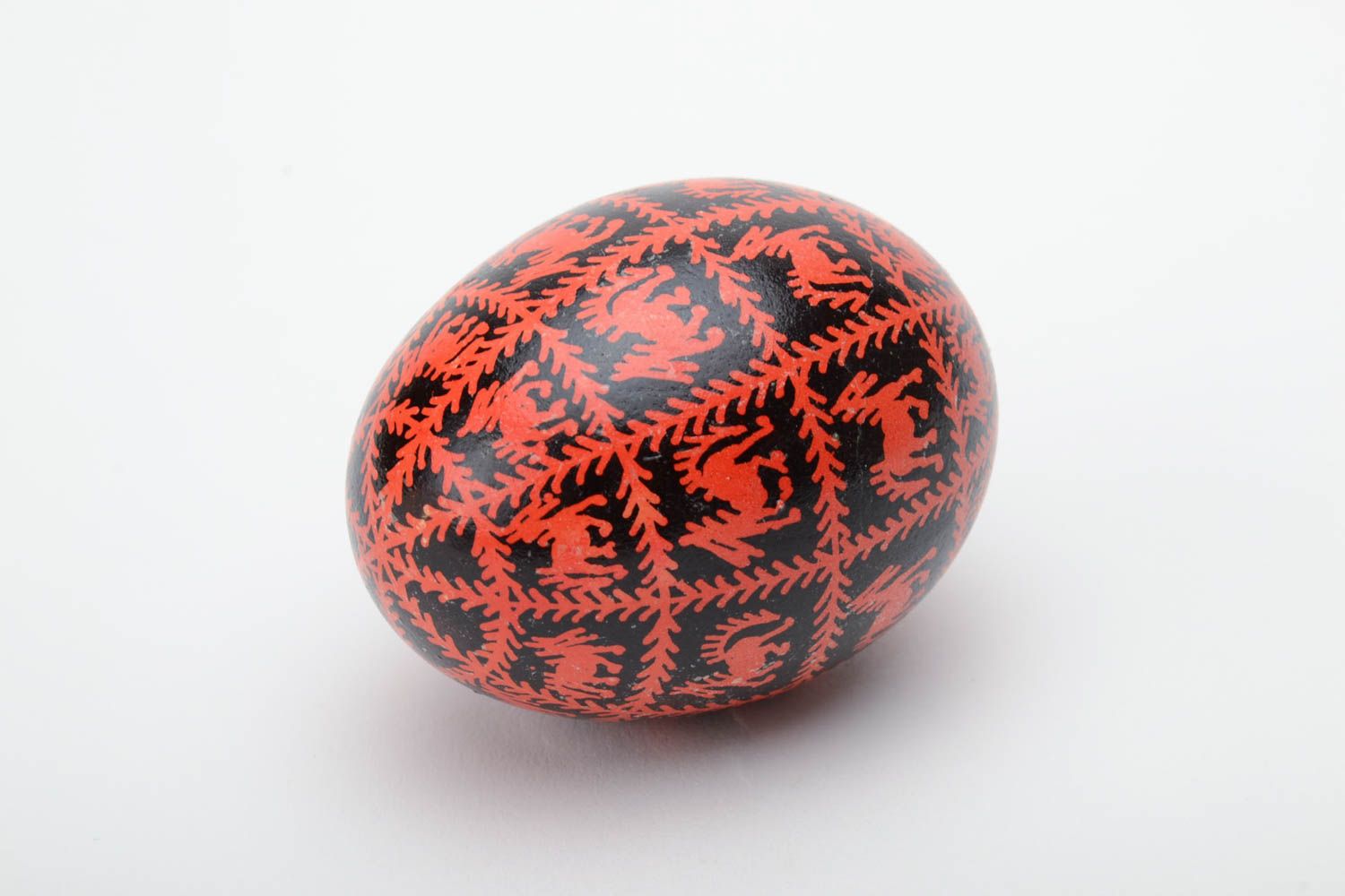 Black and red homemade painted Easter egg decorated using waxing technique photo 2