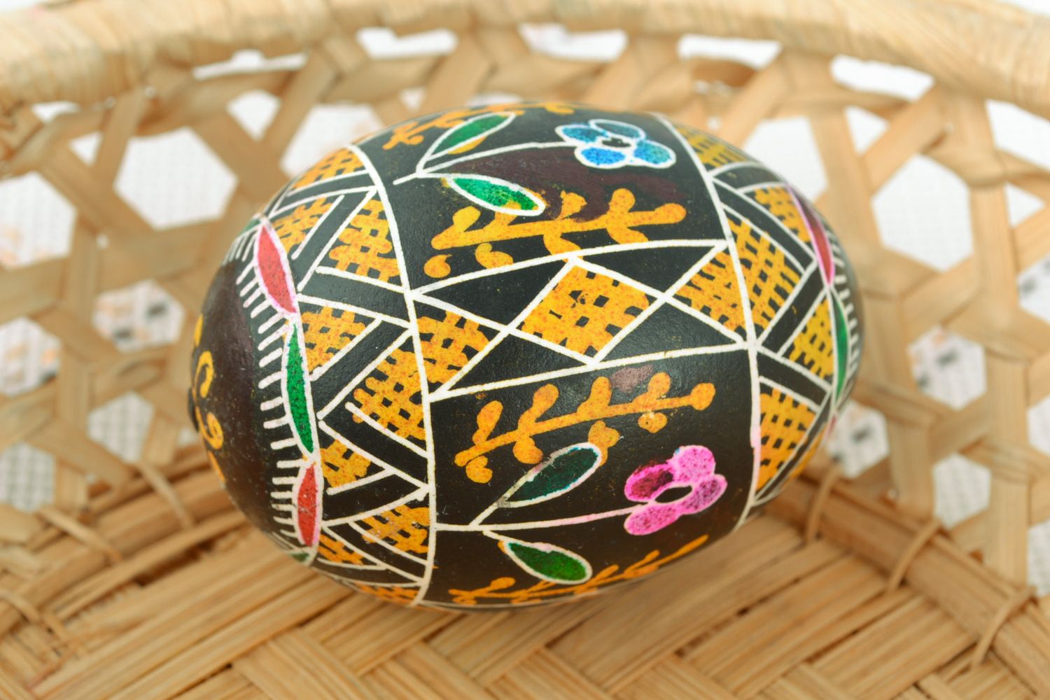 Colorful ornamented art Easter egg with handmade painting on black background photo 1