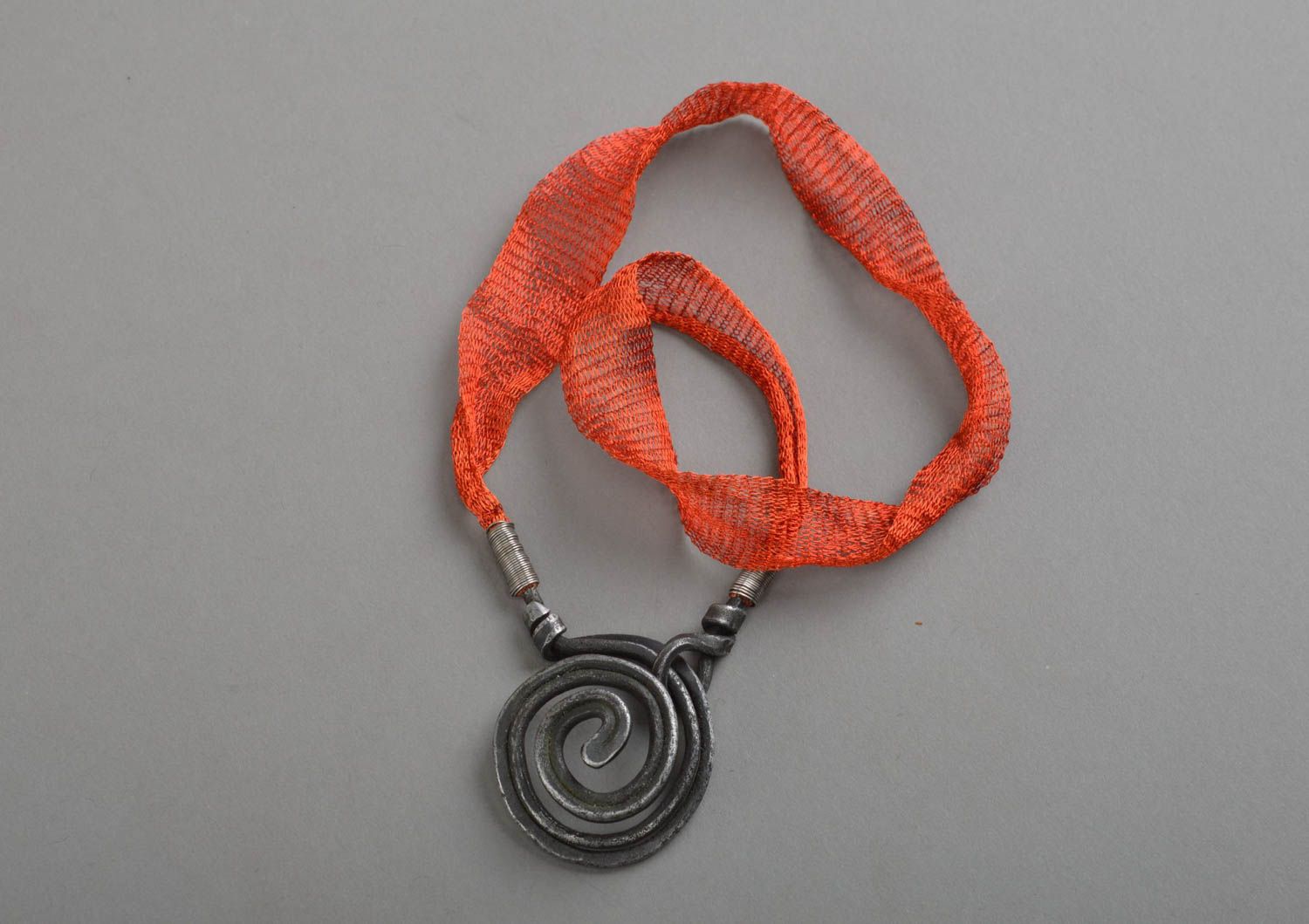 Necklace on red lace with manually forged pendant made of iron Whirl anthracite photo 2