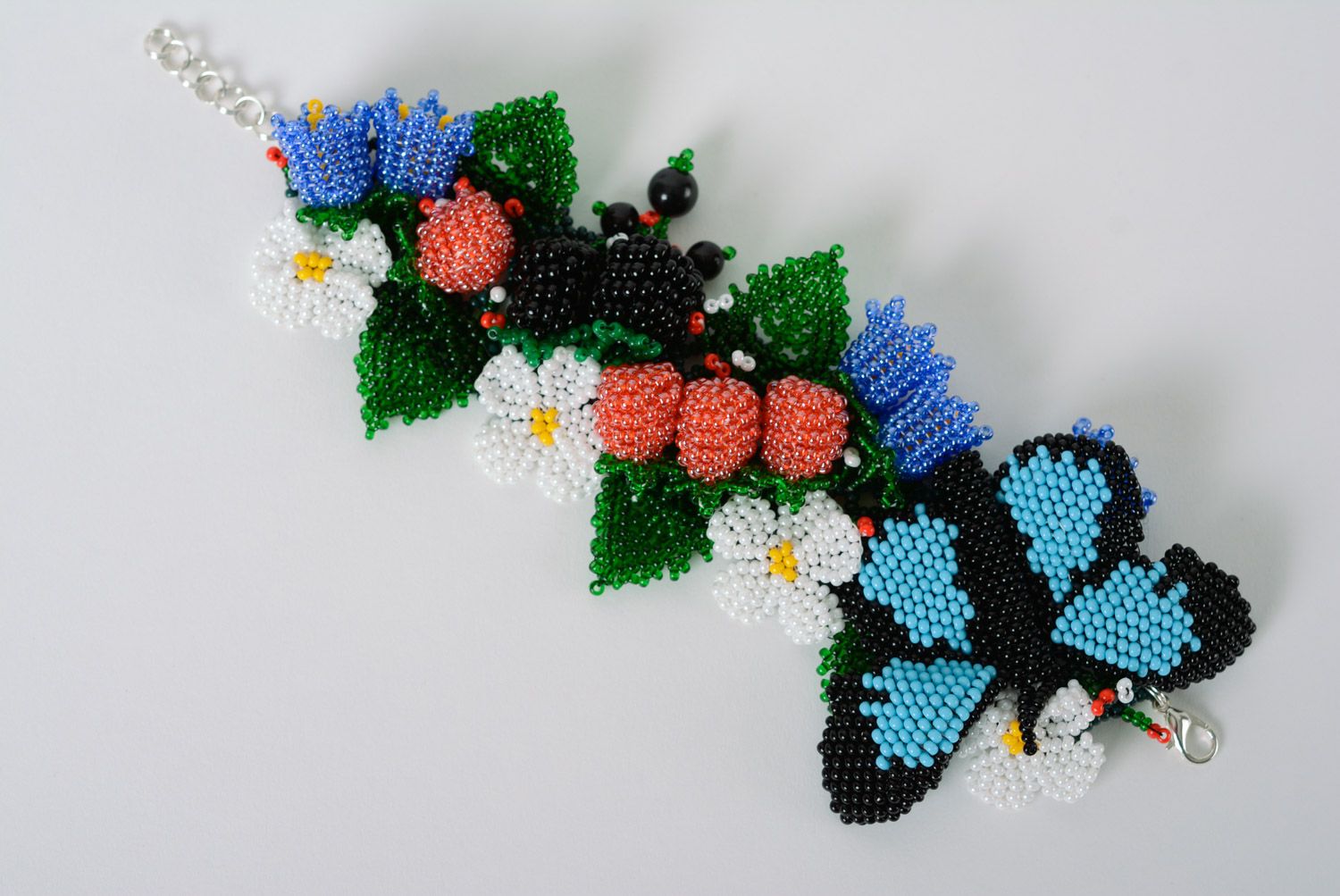 Volume handmade summer bracelet woven of beads with flowers and butterfly  photo 1