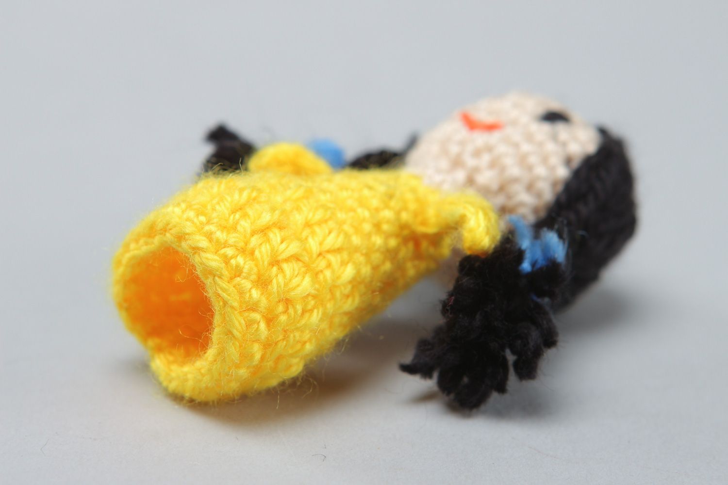 Handmade finger puppet crocheted of acrylic threads girl in yellow dress photo 3