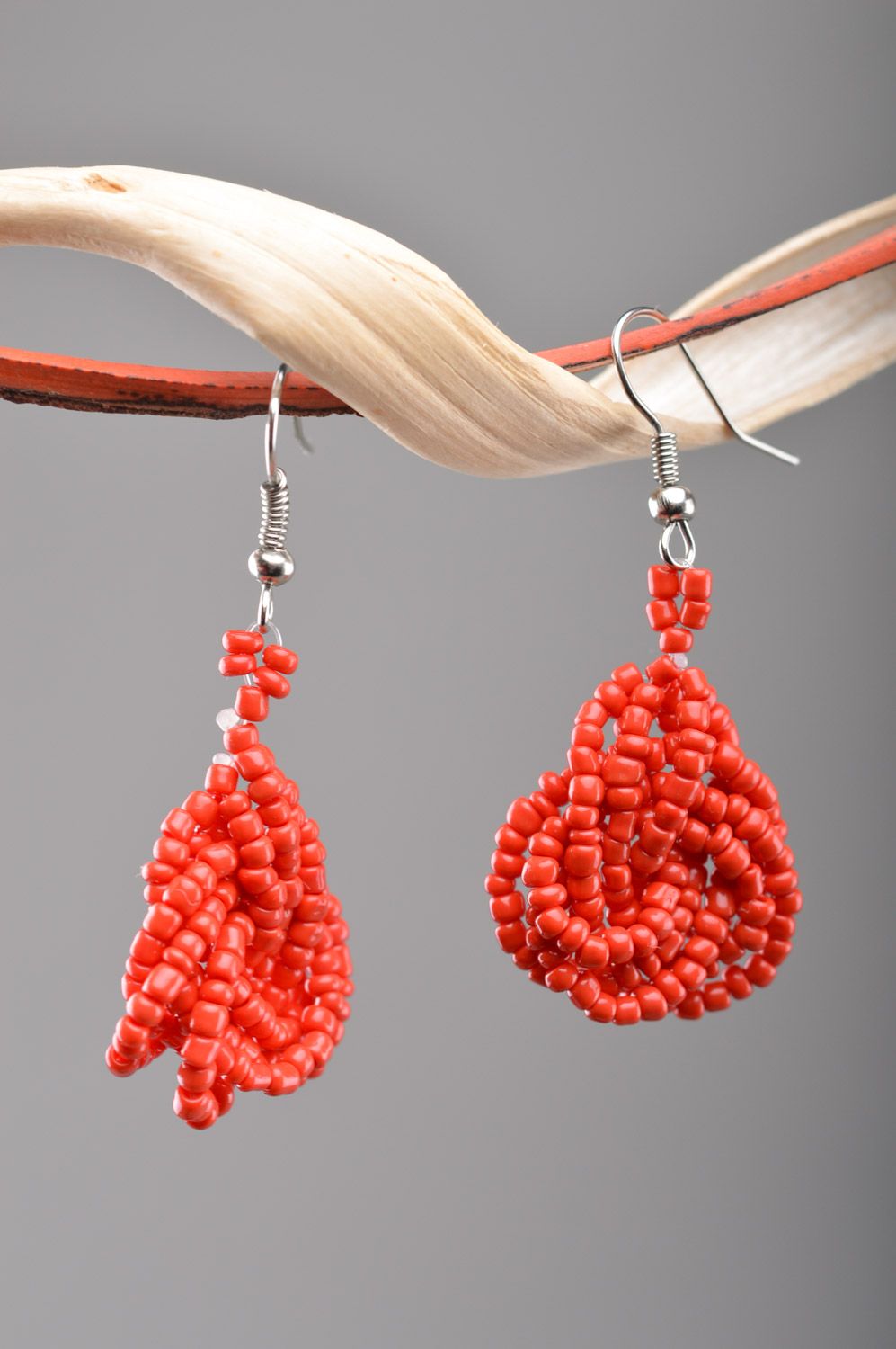 Handmade festive dangle earrings woven of Czech beads of red color photo 1