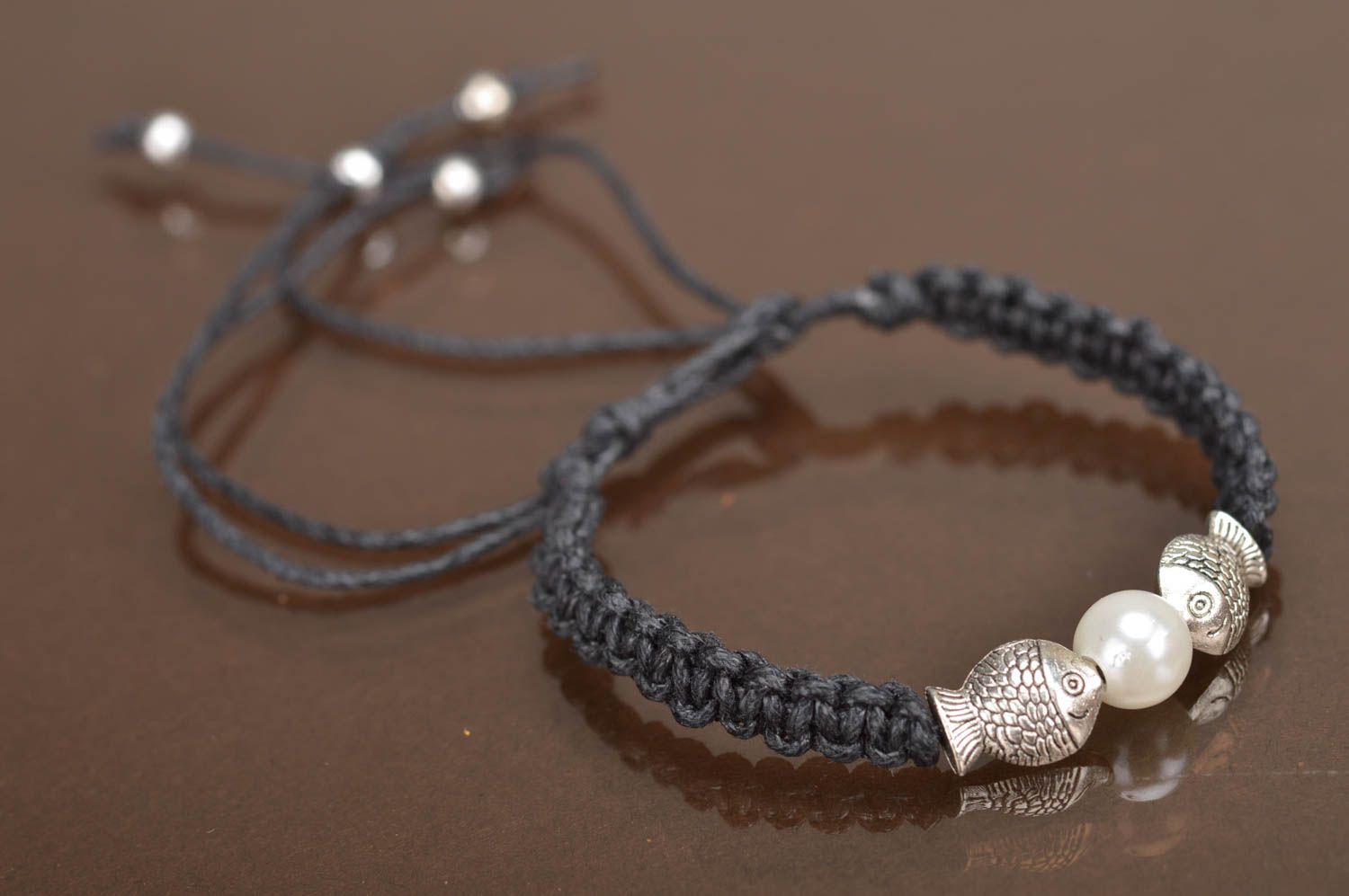 Thin black woven wrist bracelet made of lace with white bead and fittings photo 2