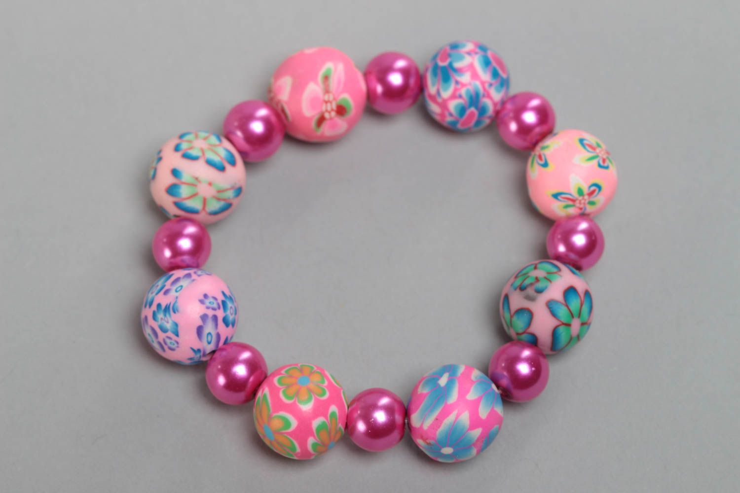 Colorful pink handmade children's plastic bracelet with beads photo 2