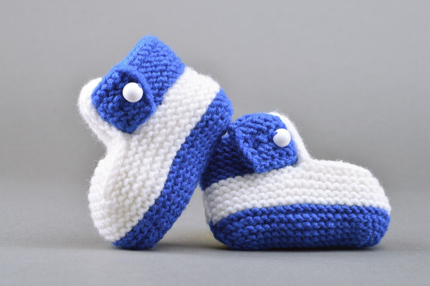 Small handmade knitted baby booties of white and blue colors for boy photo 2