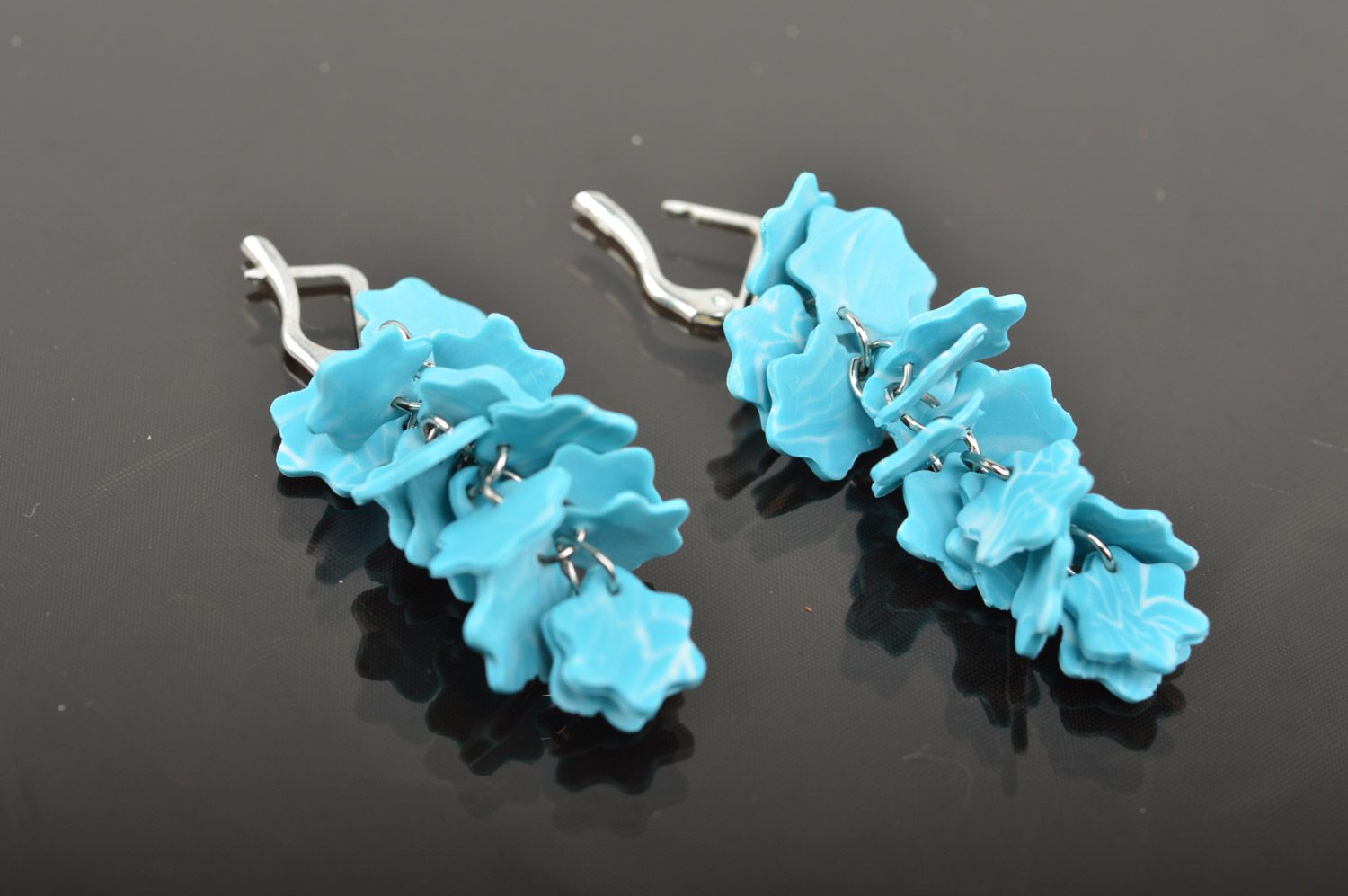 Handmade women's polymer clay flower earrings with charms in the shape of snowflakes of blue color  photo 3