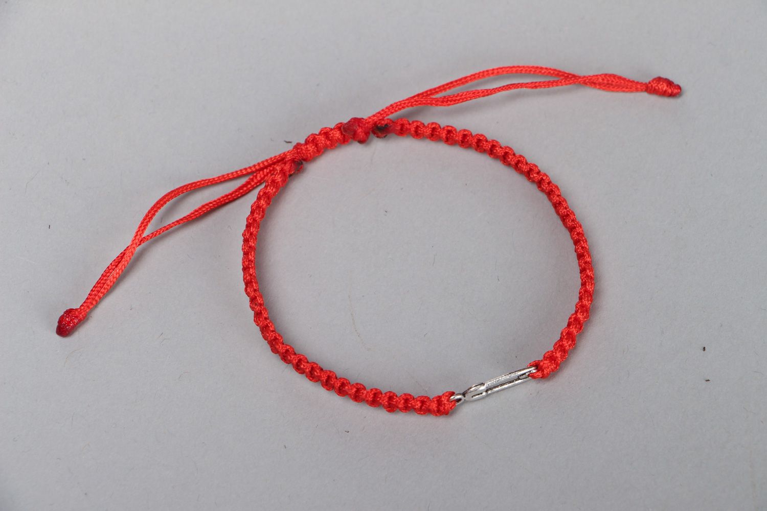 Handmade friendship bracelet woven of synthetic thread of red color with ties photo 1