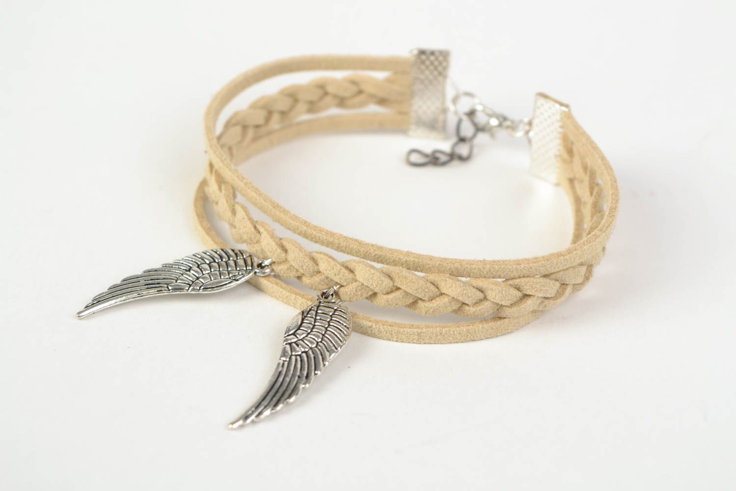 Beige handmade woven suede cord bracelet with charm in the shape of wings photo 3