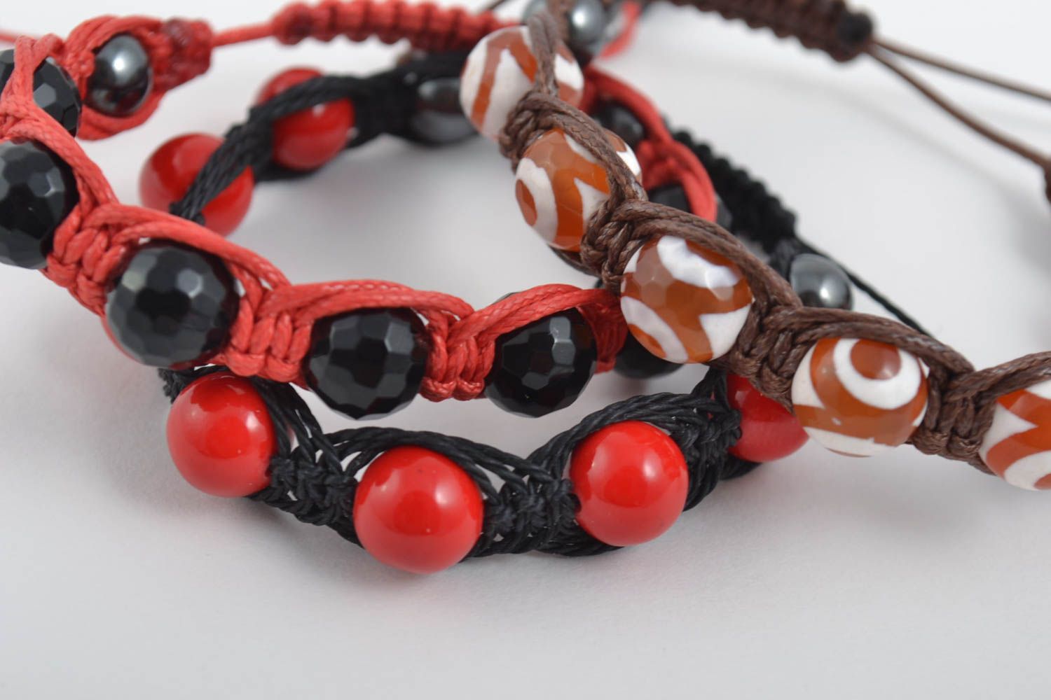 Set of three strand bracelets on red, brown, black cords with red, black, white, and brown beads for women photo 3