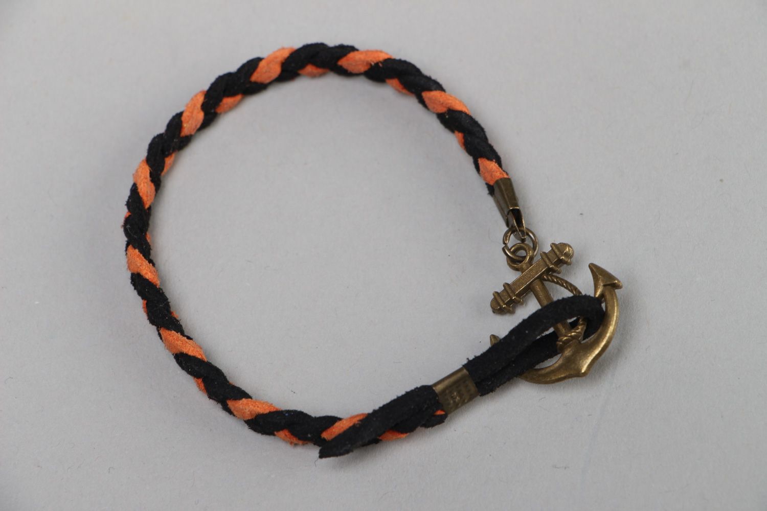 Handmade thin friendship bracelet woven of faux suede with anchor shaped charm photo 1