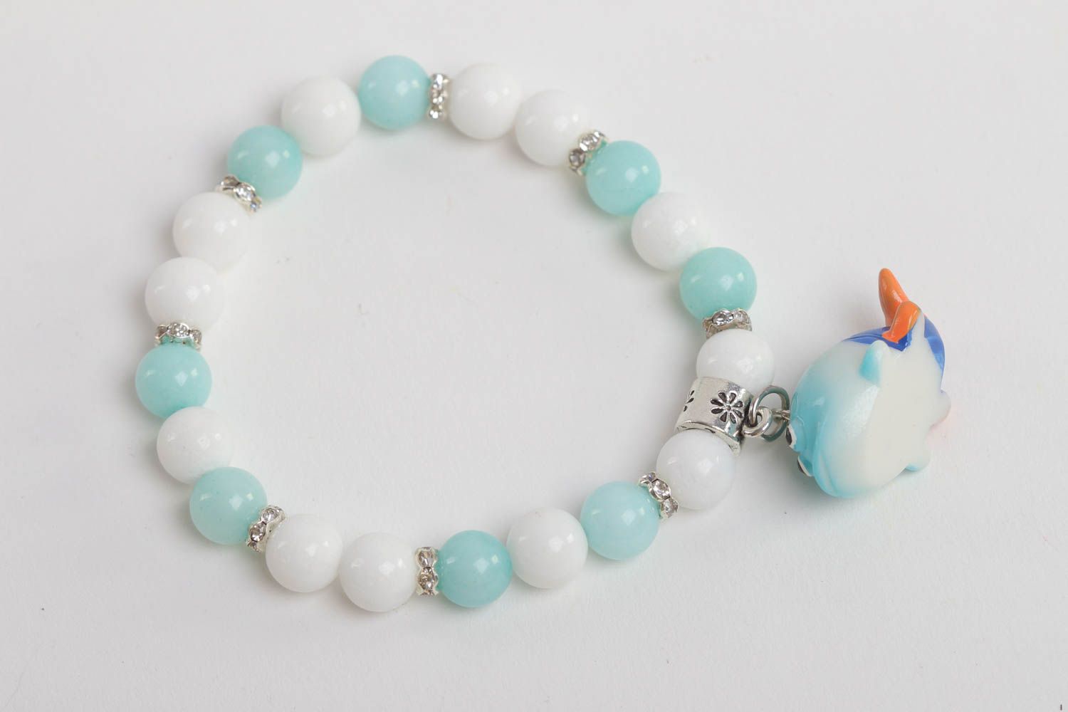 Turquoise and white beads elastic kids' bracelet with little wale charm  photo 2