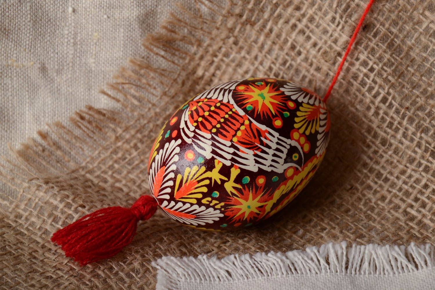 Handmade decorative painted Easter egg ornamented in Lemkiv style with red tassel photo 1