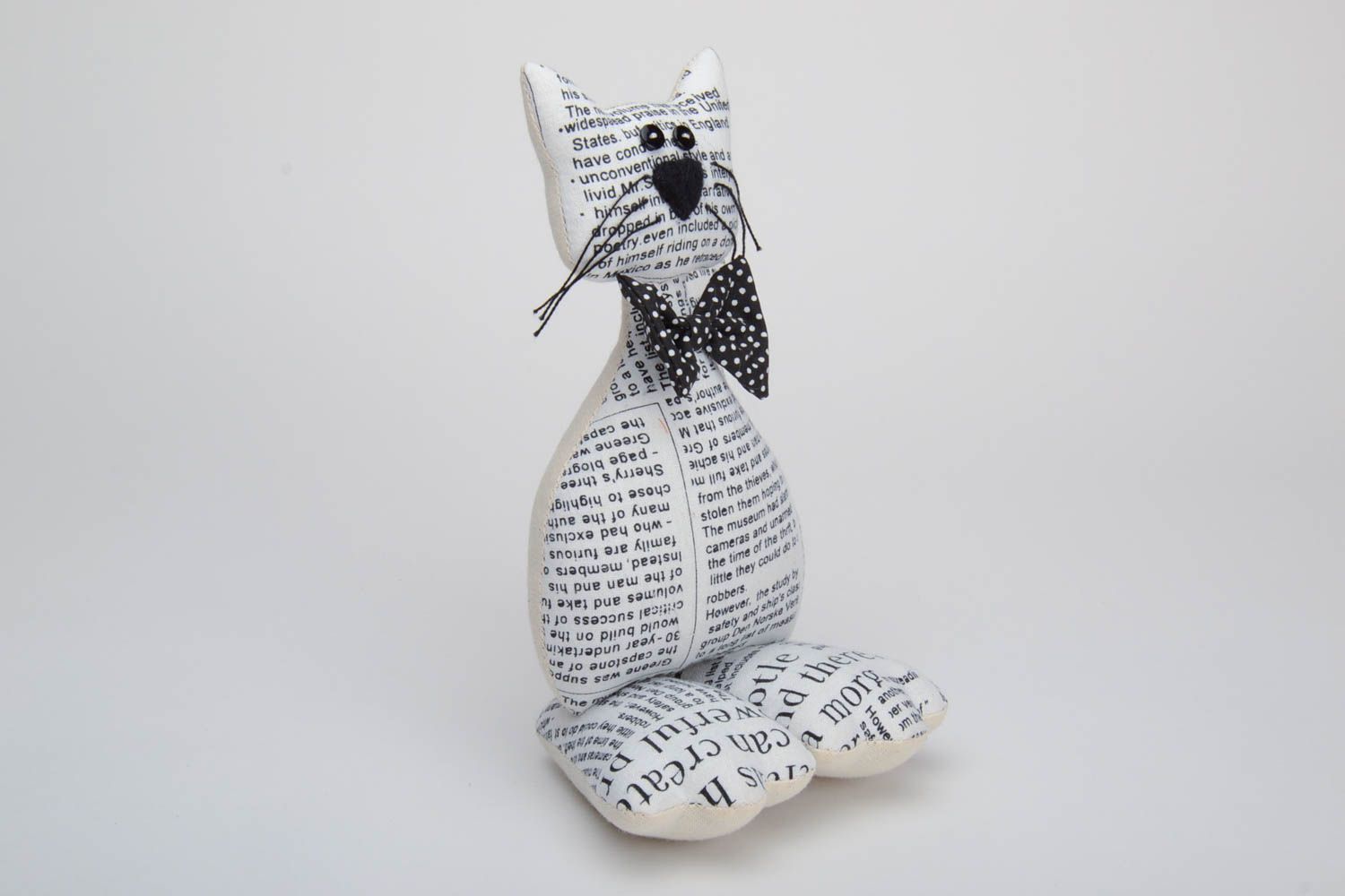 Handmade soft toy sewn of cotton with newspaper pattern Cat with black bow tie photo 2