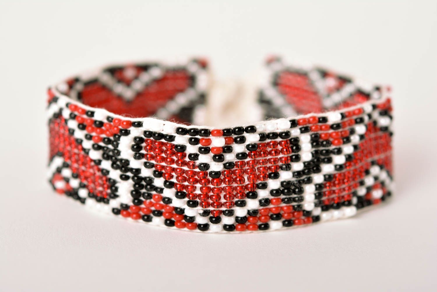 Handmade beaded bracelet with Ukrainian style ornament in red, black, and white color photo 1