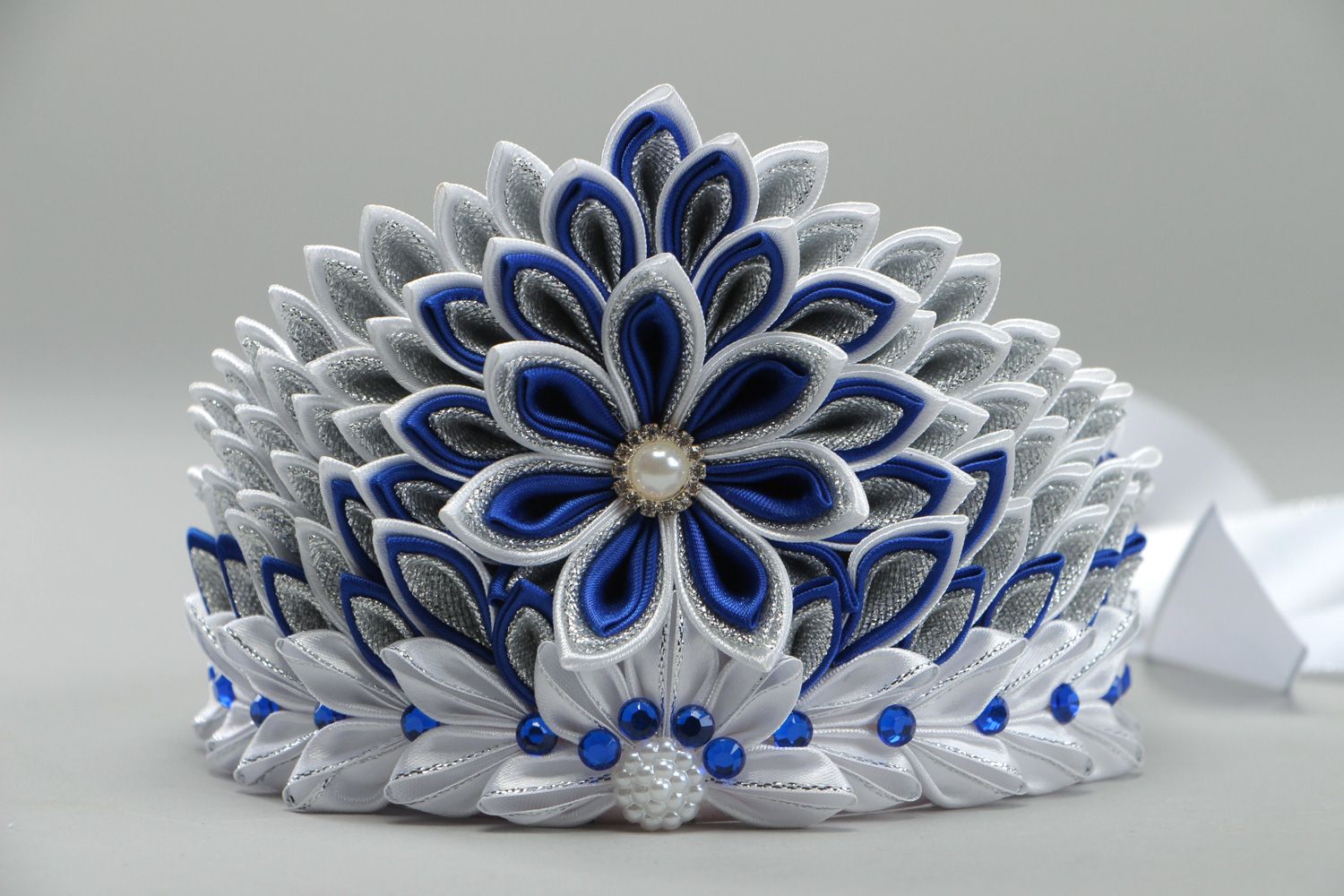 Beautiful volume handmade crown with satin ribbons in white and blue color palette photo 2