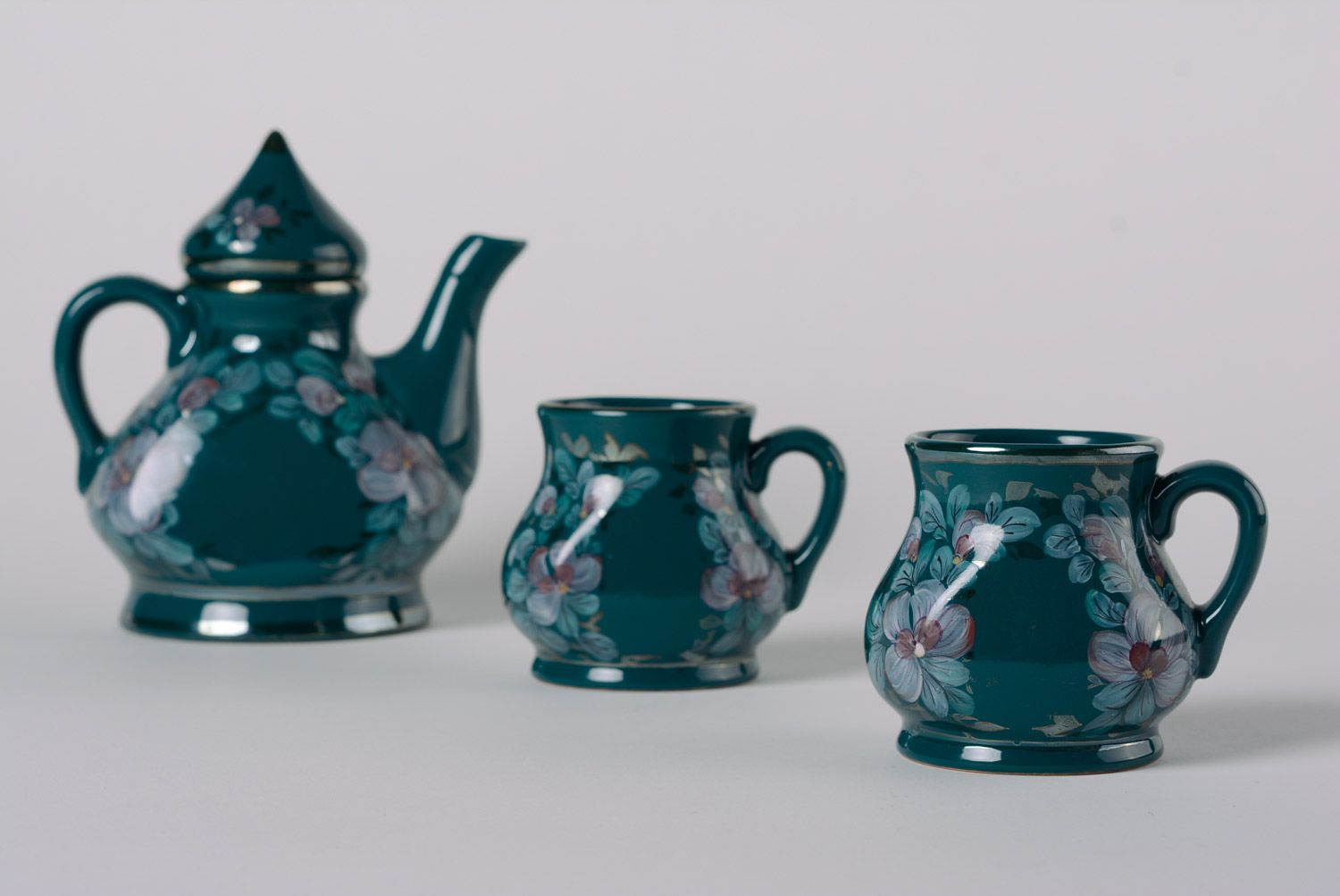 Decorative elegant dark blue porcelain teapot and two cups with flower pattern  photo 1