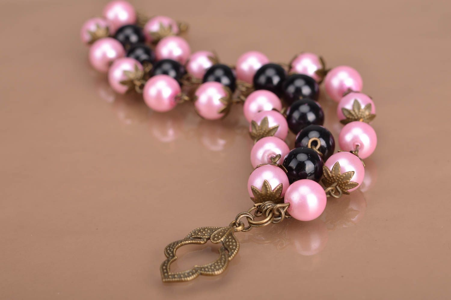 Handmade designer women's wrist bracelet with pink and black beads and charm photo 5