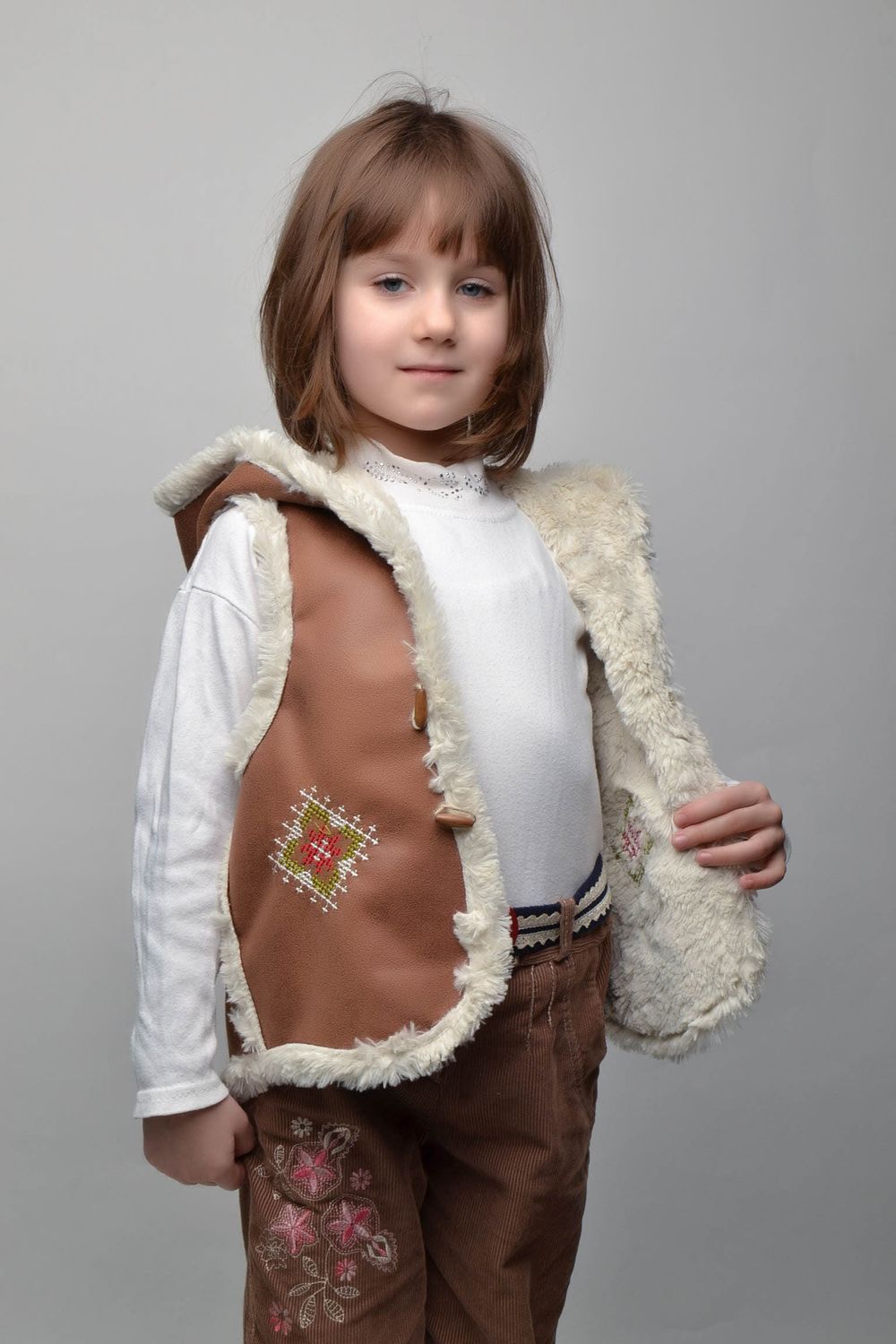 Artificial fur children's vest with hood and buttons photo 4