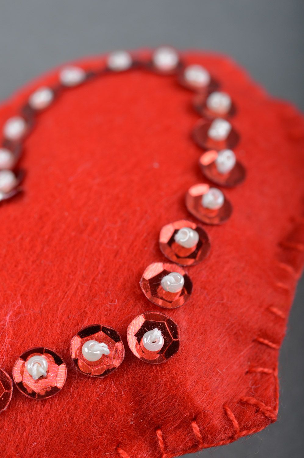 Handmade soft toy heart sewn of red felt decorated with spangles for interior photo 2