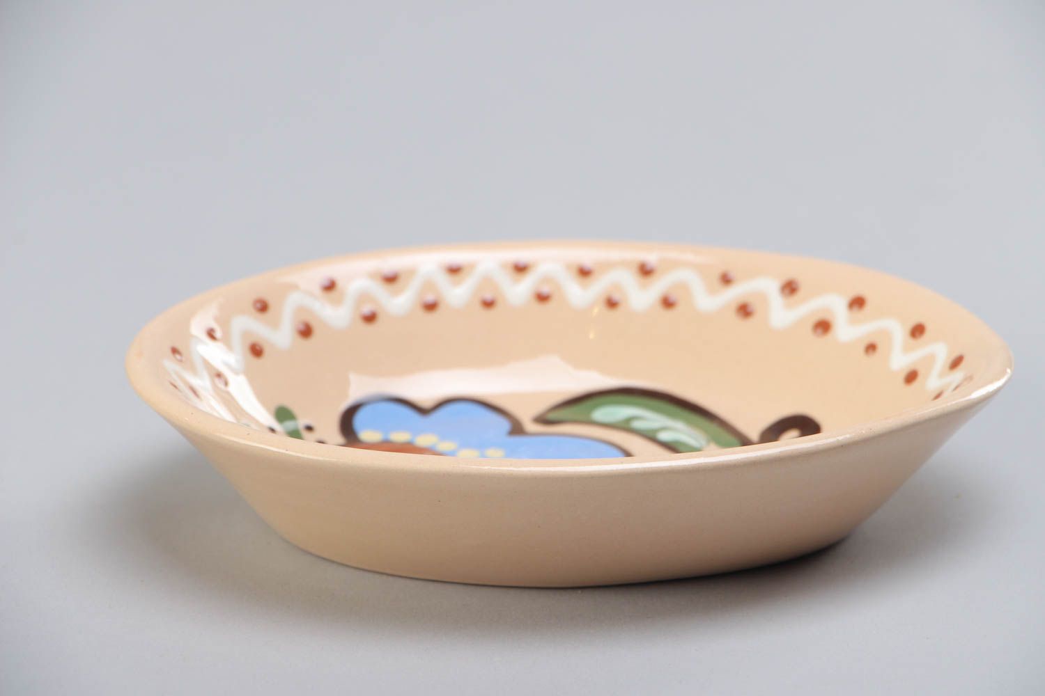 Light ceramic bowl with handmade floral painting with glaze in ethnic style  photo 2