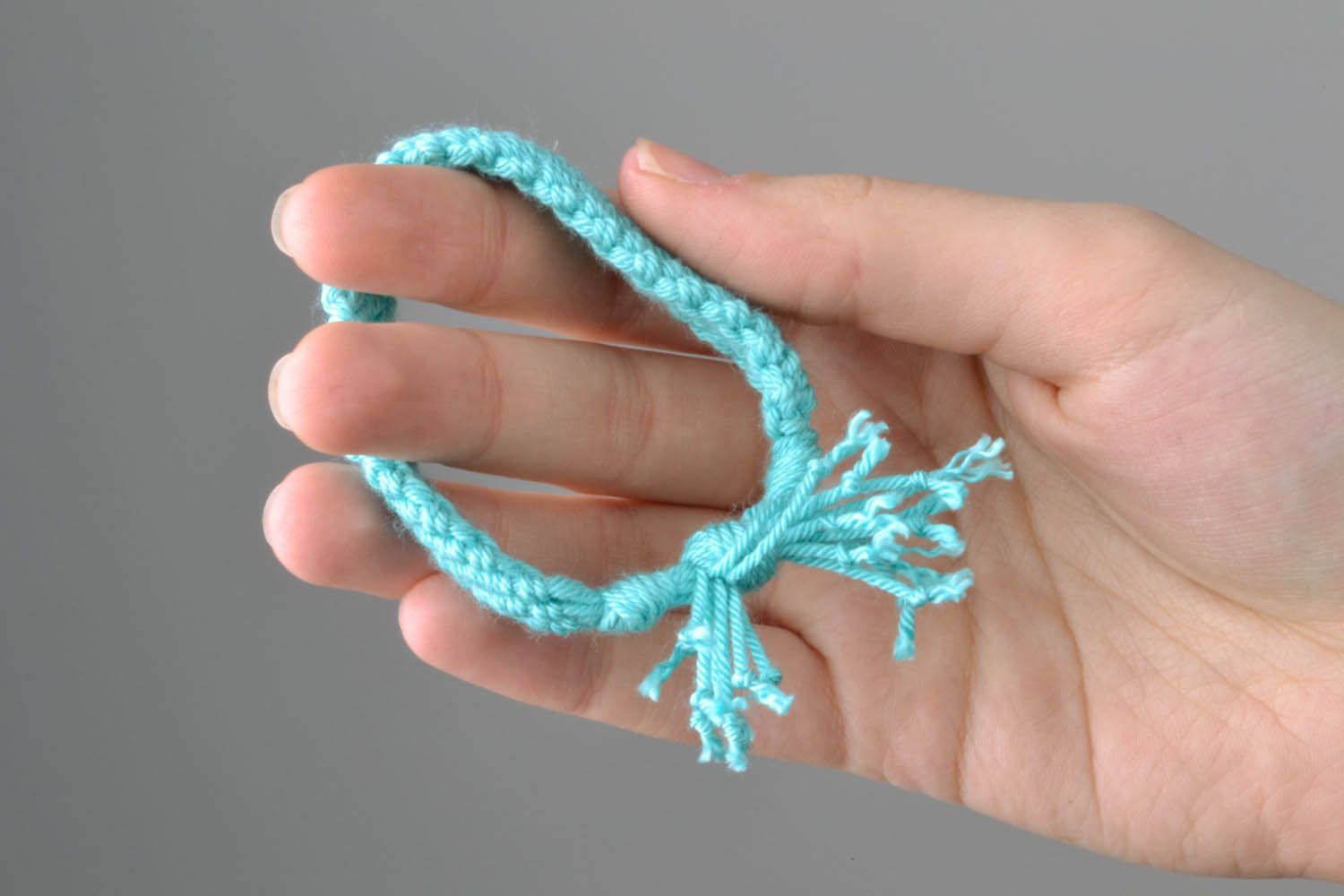 Braided bracelet made of blue threads photo 2