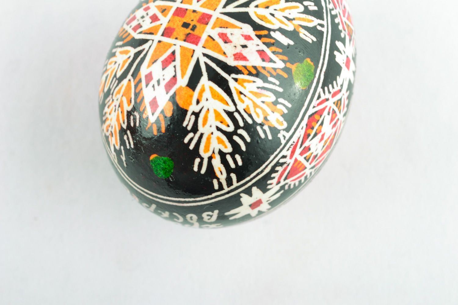 Handmade Easter egg with rich ornament on black background painted with hot wax  photo 4