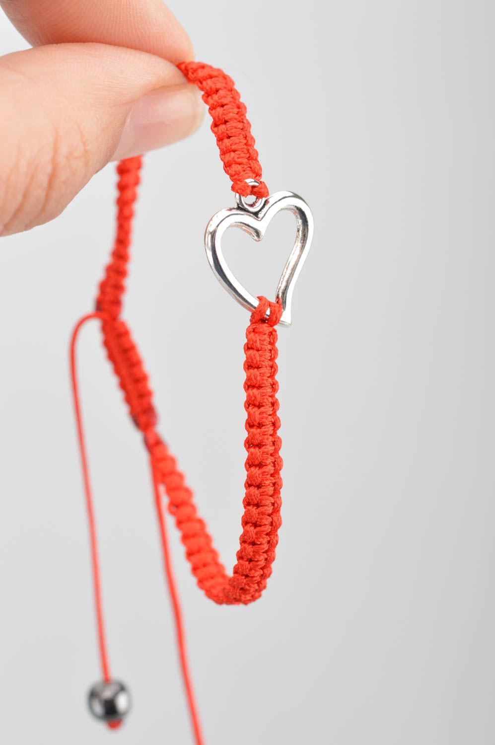 Handmade red bracelet made of silk threads with insert in shape of heart photo 3