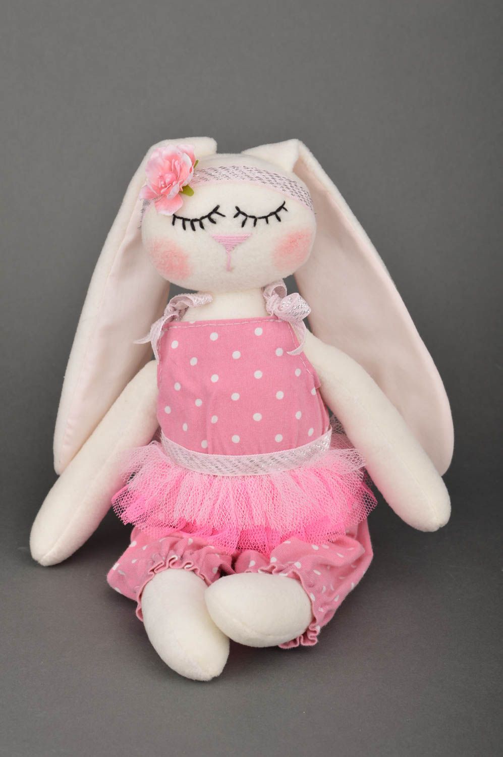 Handmade soft toy sewn of cotton fabric rabbit in pink clothing for children photo 2