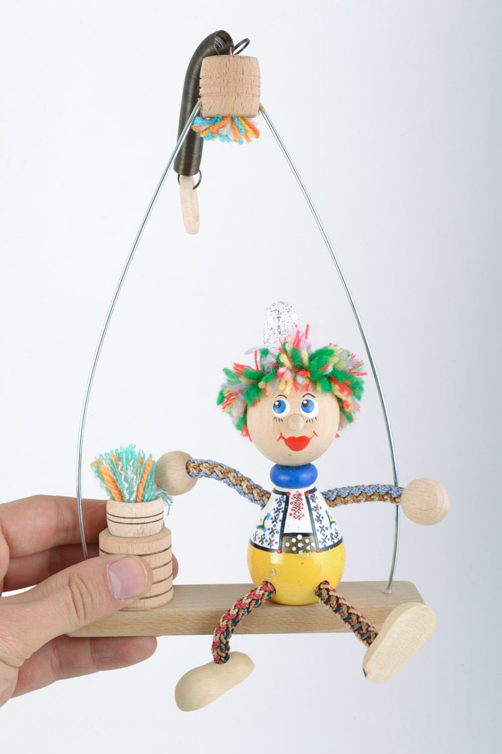 Helles schönes originelles handgemachtes Öko Spielzeug aus Holz Junge auf Bank  foto 2