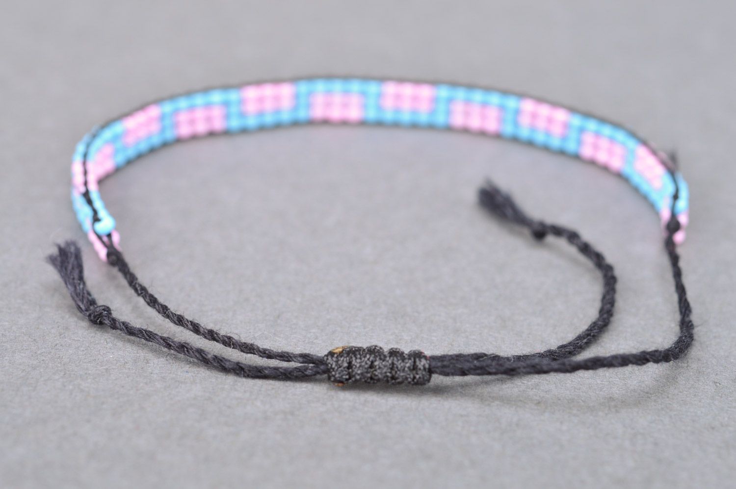 Thin handmade wrist bracelet woven of pink and blue beads with ties for women photo 5